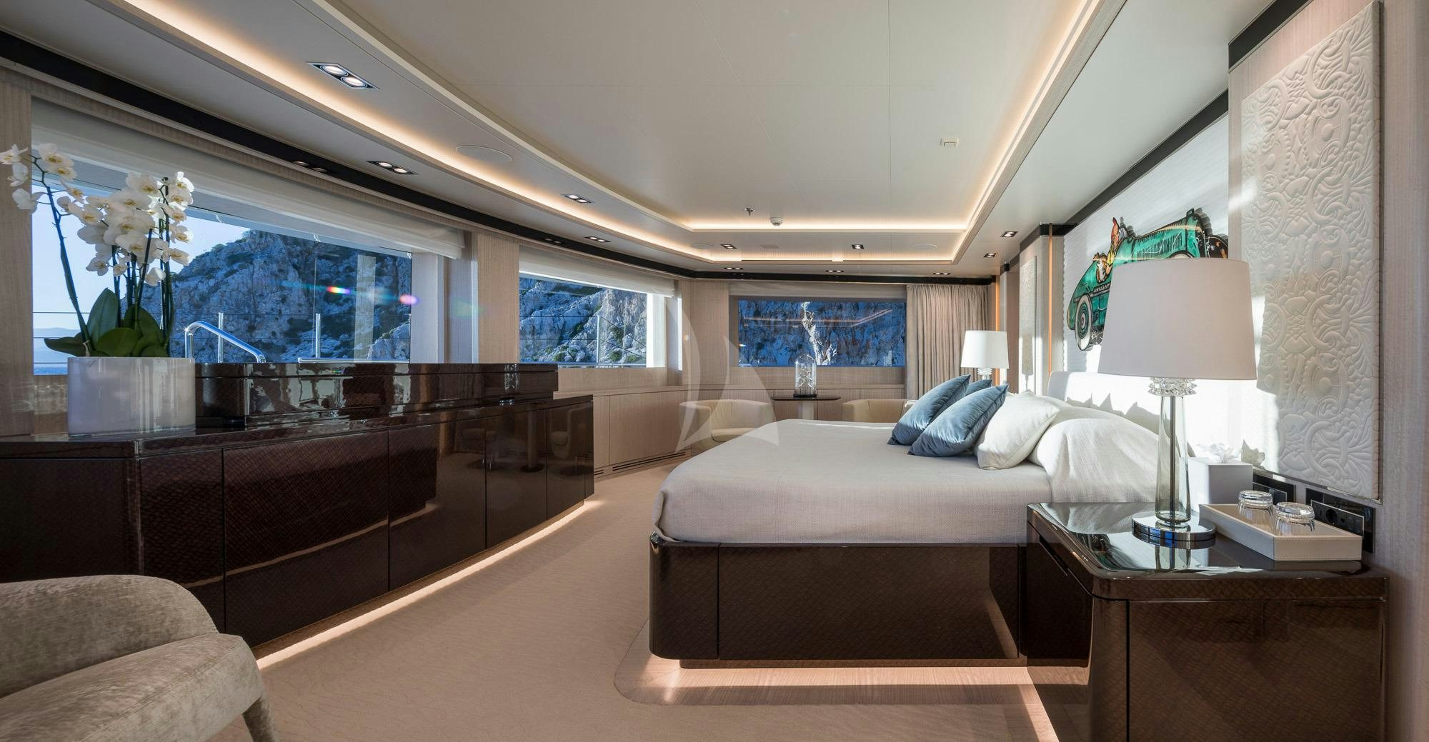 a room with a bed and a desk aboard O'PTASIA Yacht for Sale