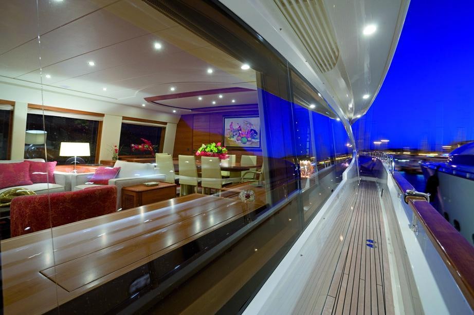 a long row of seats in a room with a large window aboard LADY EMMA Yacht for Charter