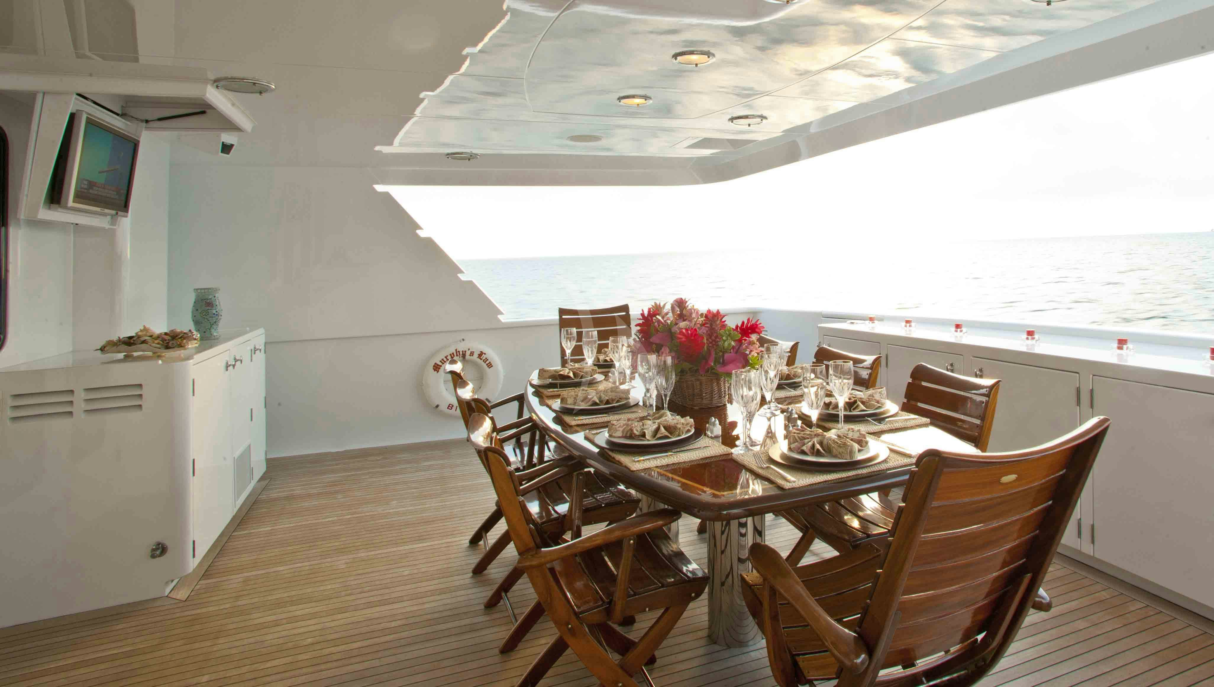 a dining room with a table and chairs aboard MURPHY'S LAW Yacht for Charter