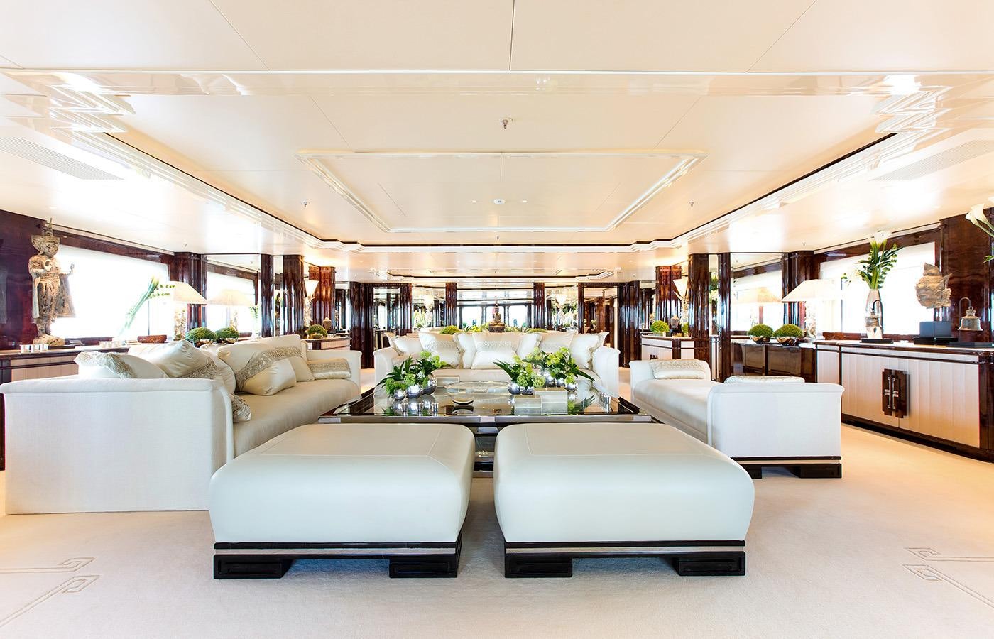 a living room with white furniture aboard LIONESS V Yacht for Charter