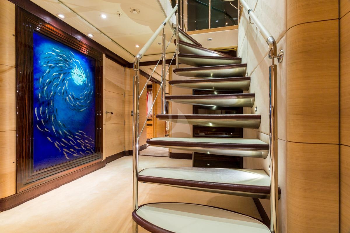 a staircase with a glass window aboard Q Yacht for Charter