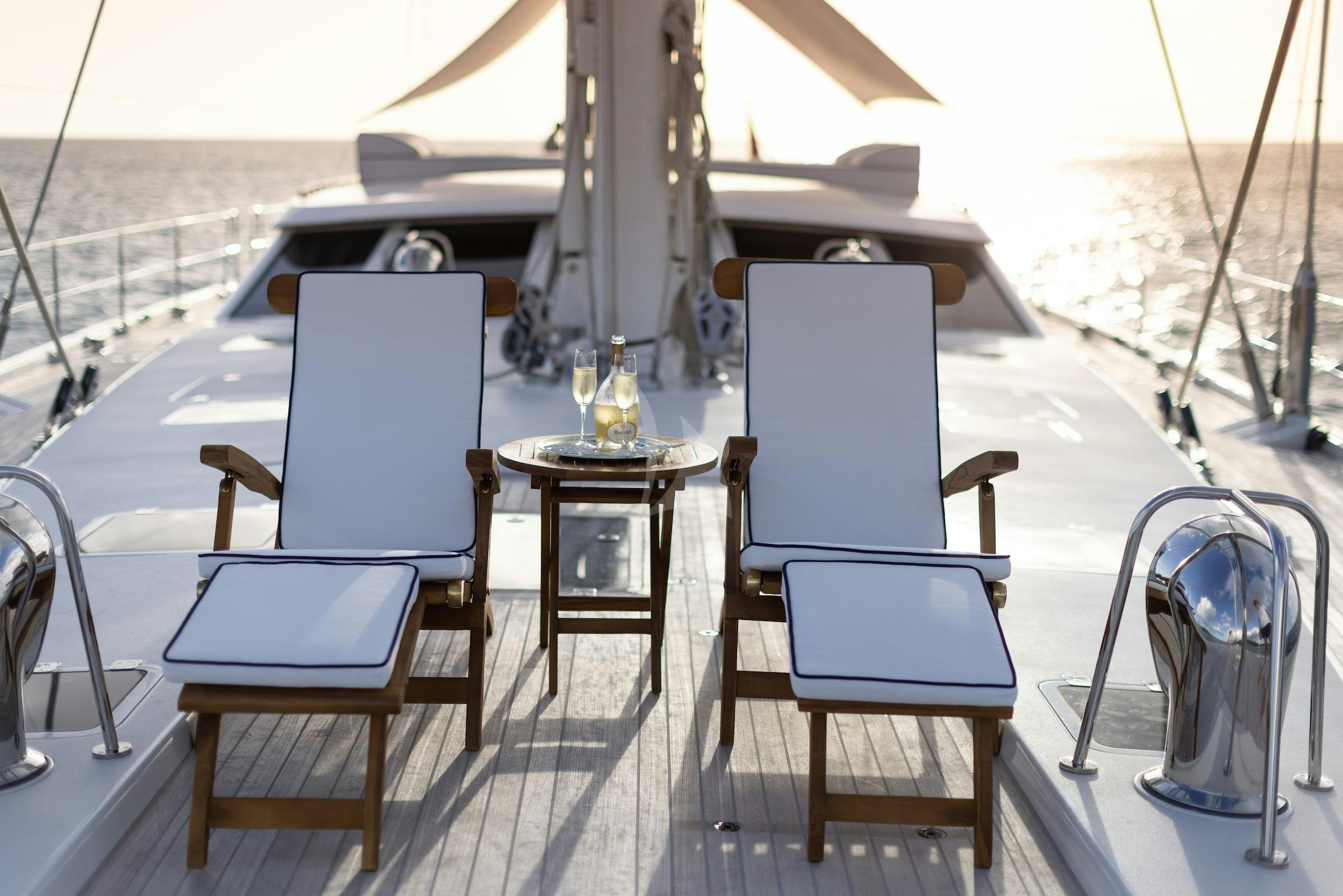 a table and chairs on a deck aboard CAVALLO Yacht for Charter
