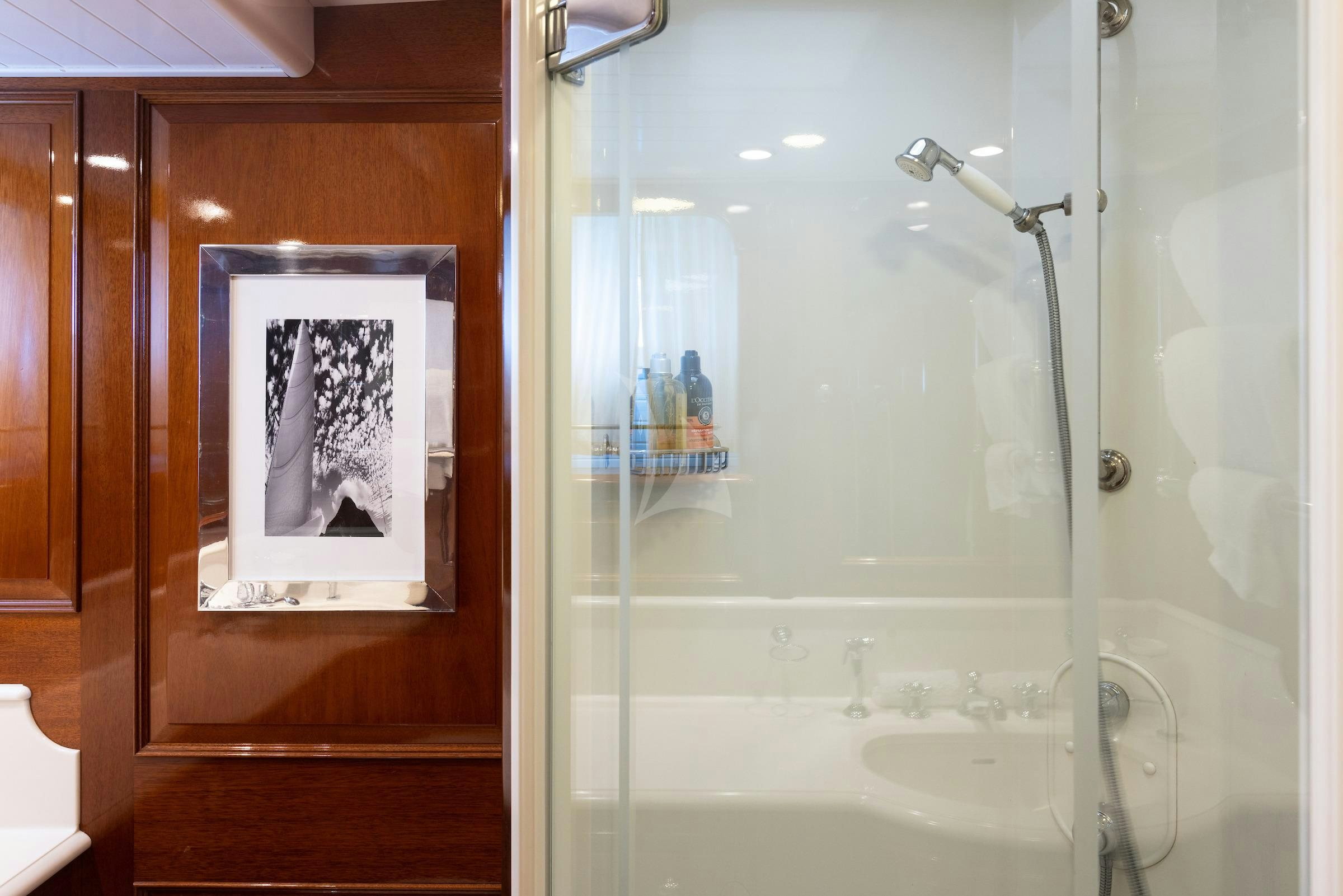 a shower with a picture on the wall aboard CAVALLO Yacht for Charter