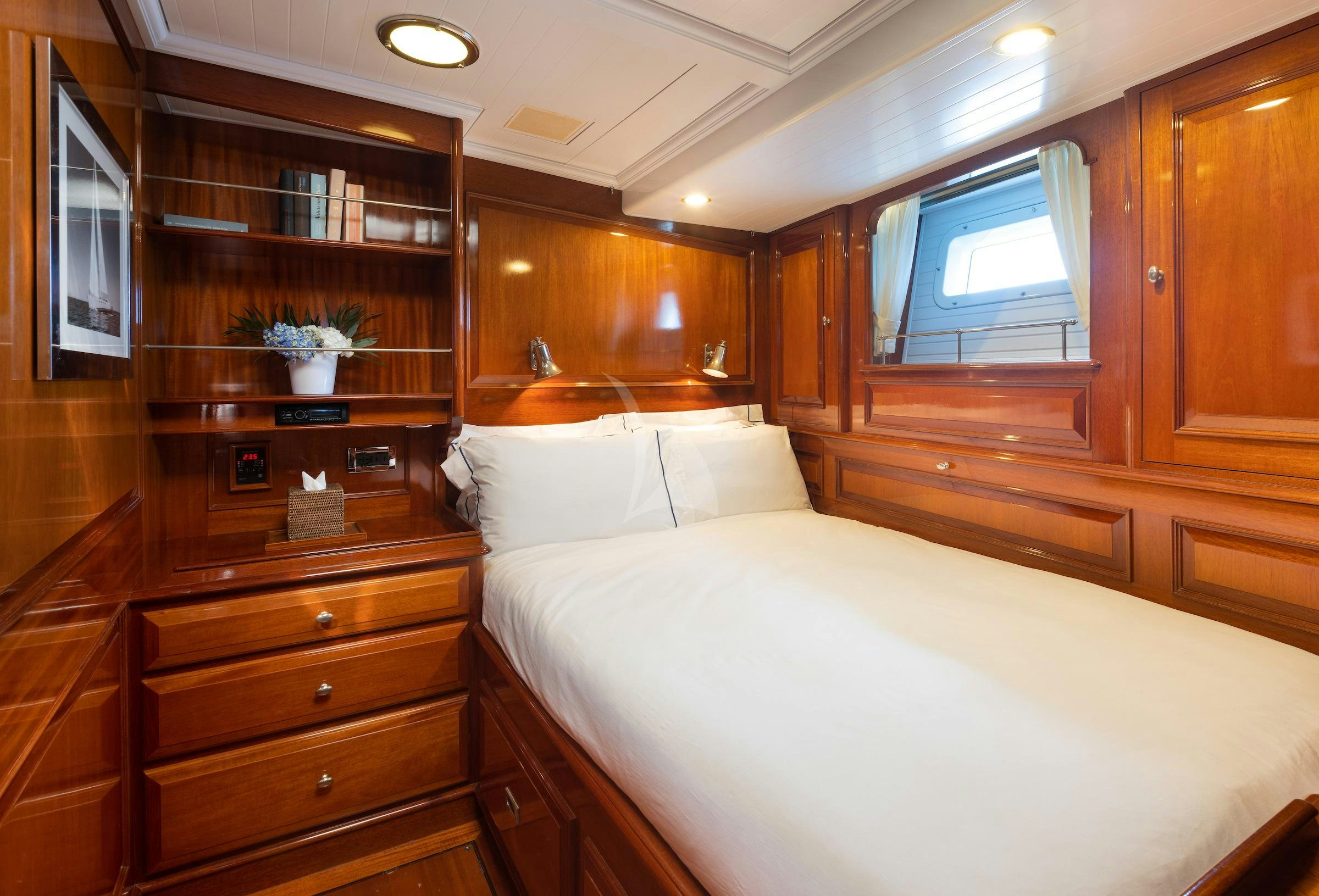 a bedroom with a bed and a shelf aboard CAVALLO Yacht for Charter