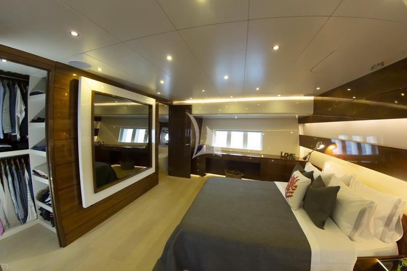 a room with a bed and a mirror aboard MUSIC Yacht for Charter