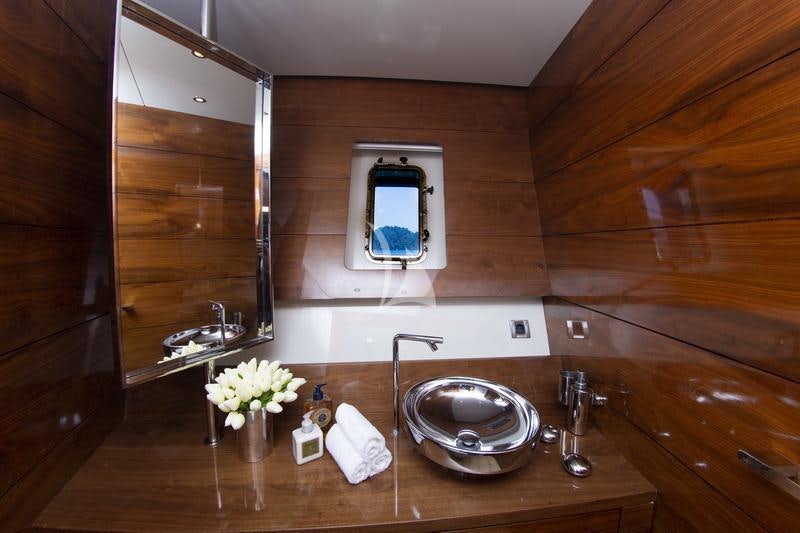 a bathroom with a sink and mirror aboard MUSIC Yacht for Charter
