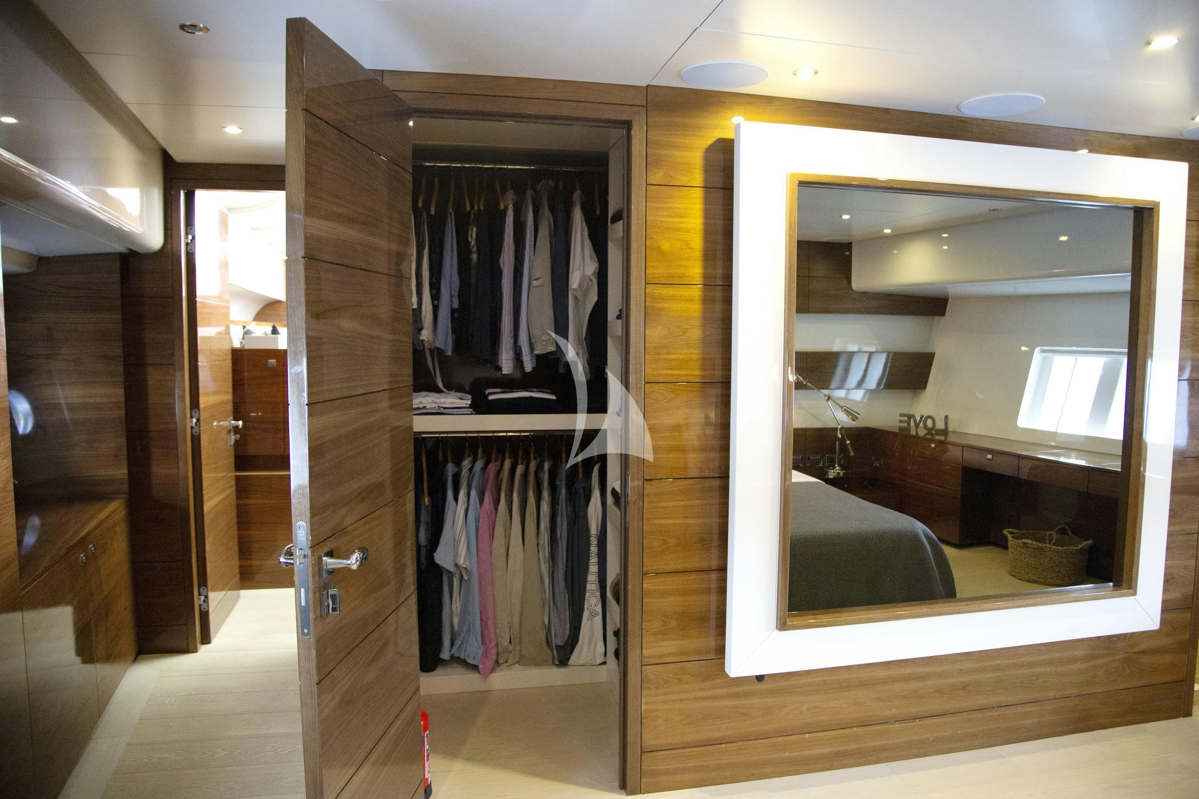 a closet with clothes on the rack aboard MUSIC Yacht for Charter