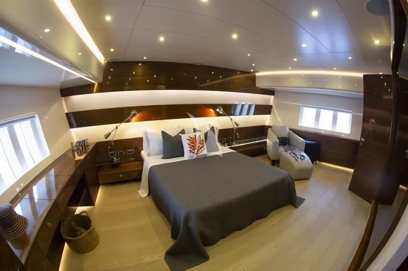 a room with a bed and a couch aboard MUSIC Yacht for Charter