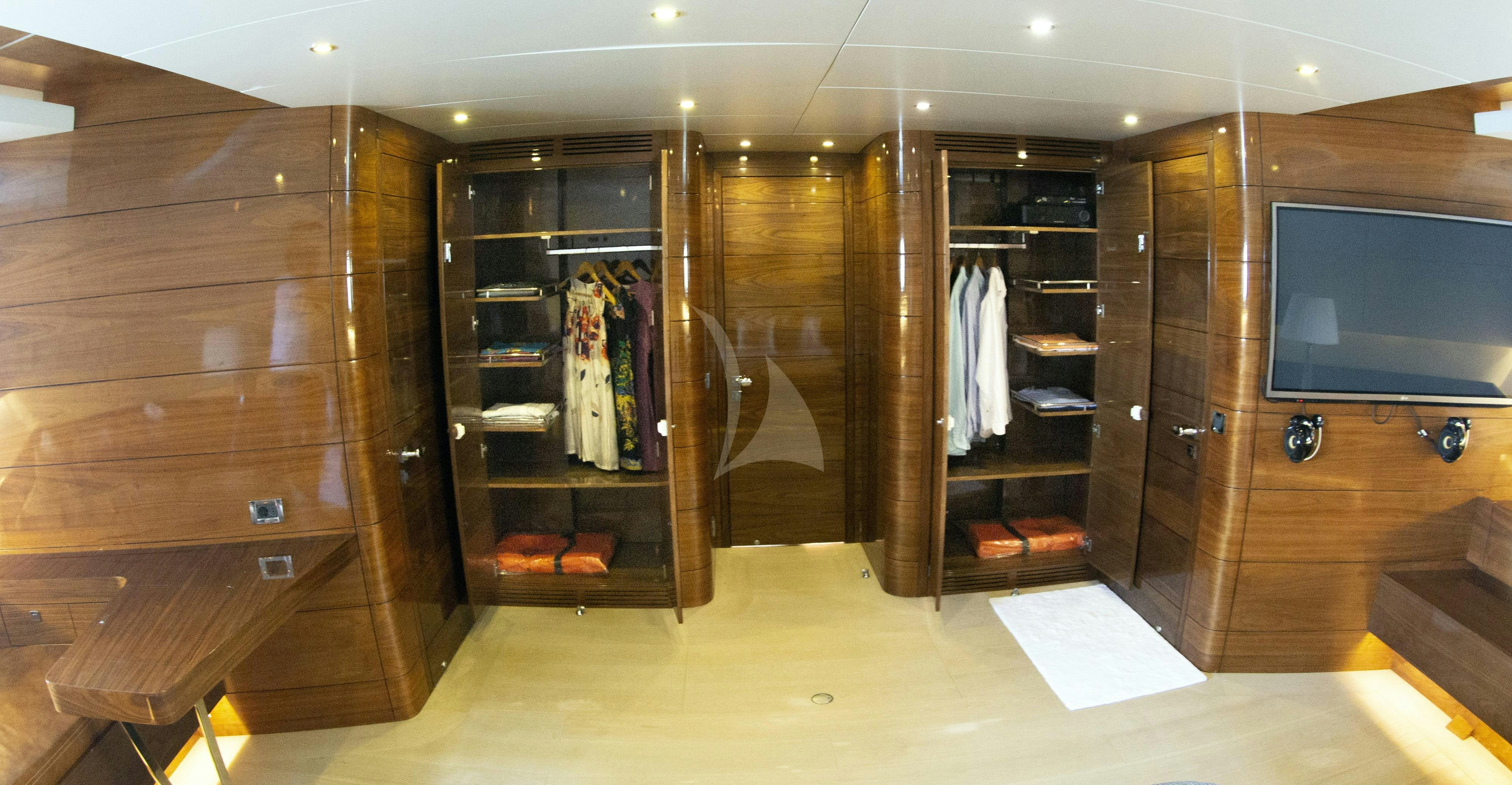 a room with a closet and a tv aboard MUSIC Yacht for Charter