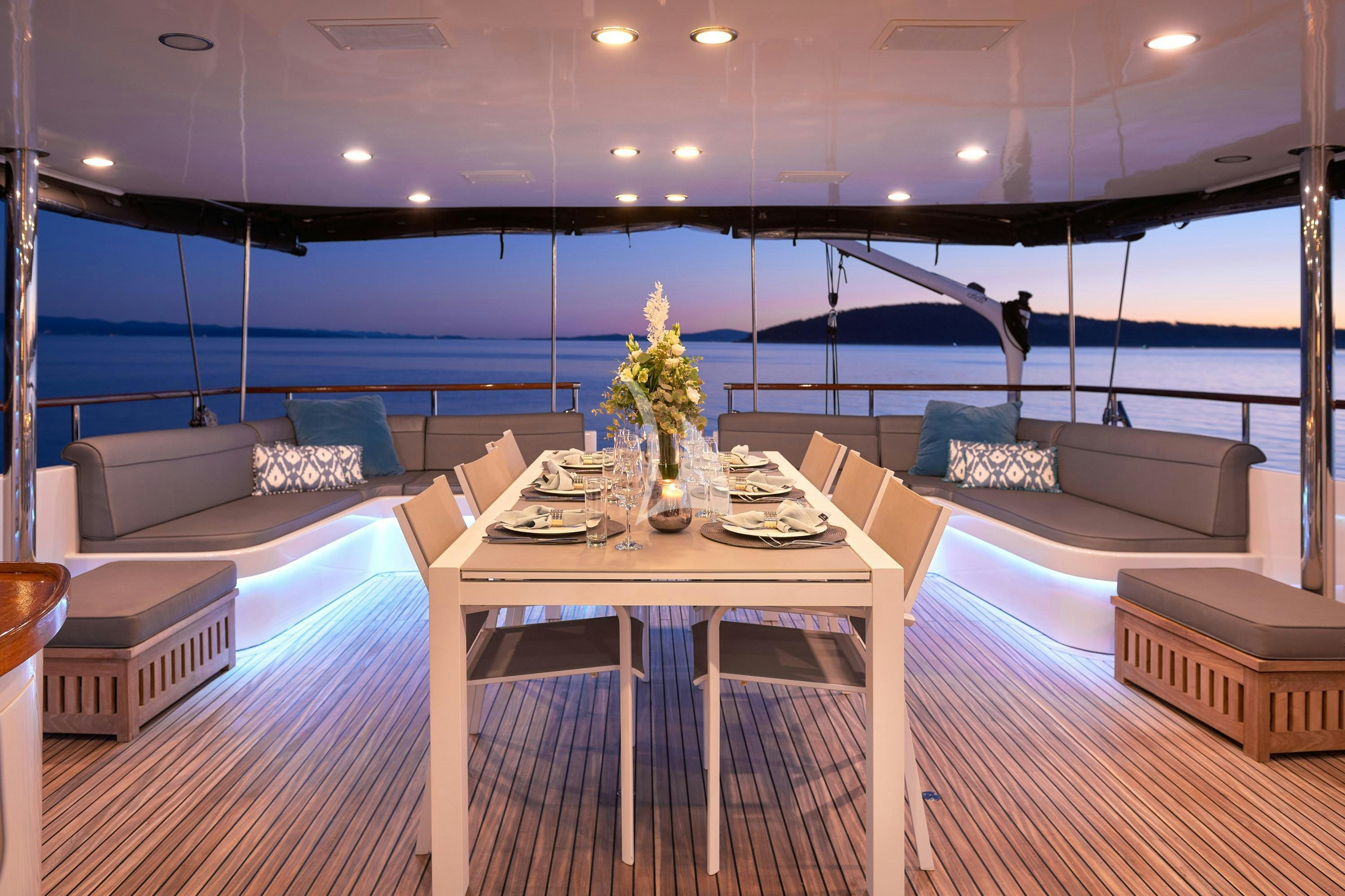 a room with a table and couches aboard SAN LIMI Yacht for Charter