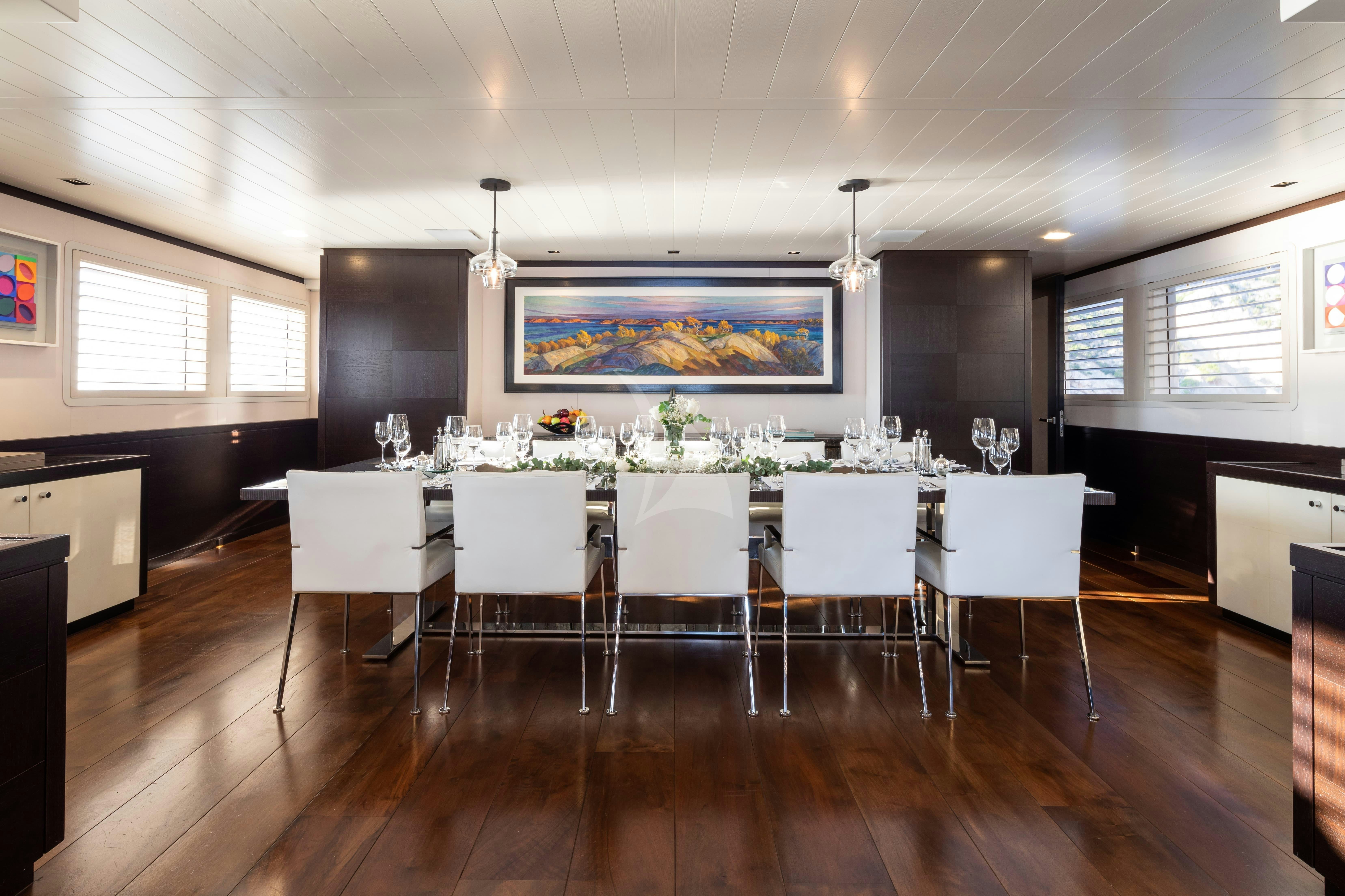 a room with a table and chairs aboard MIRAGE Yacht for Charter