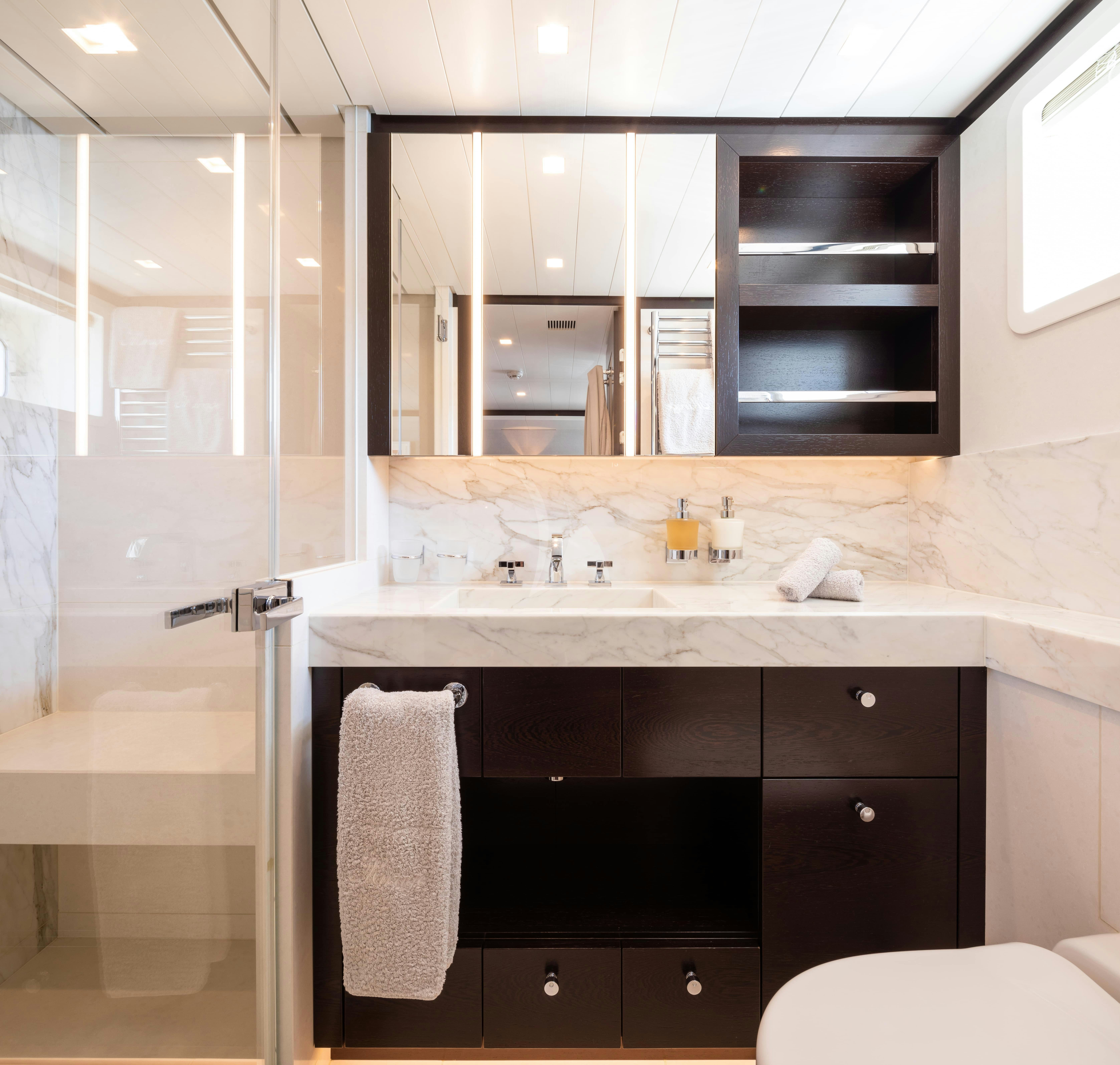 a bathroom with a sink and a mirror aboard MIRAGE Yacht for Charter