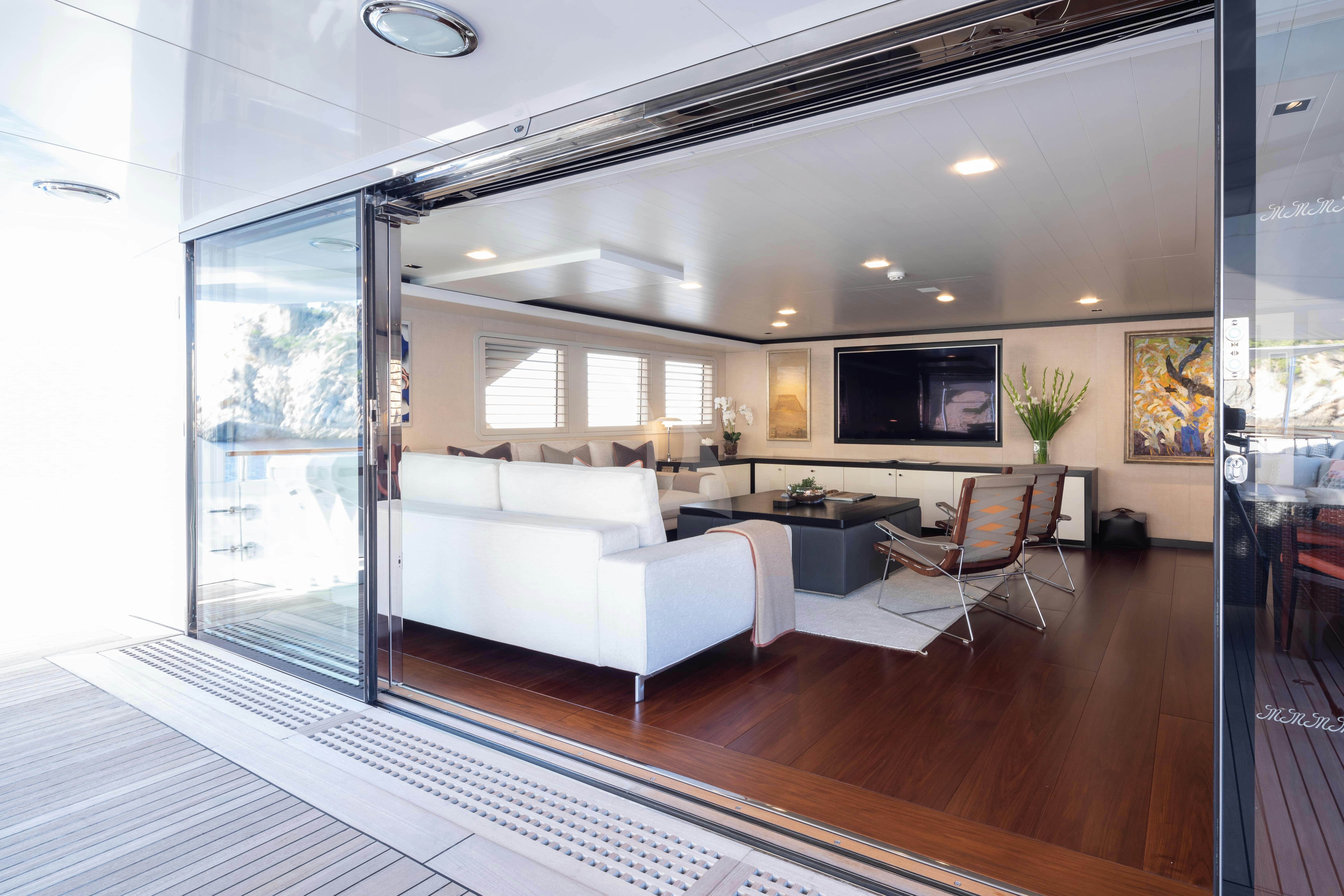a room with a couch and a tv aboard MIRAGE Yacht for Charter