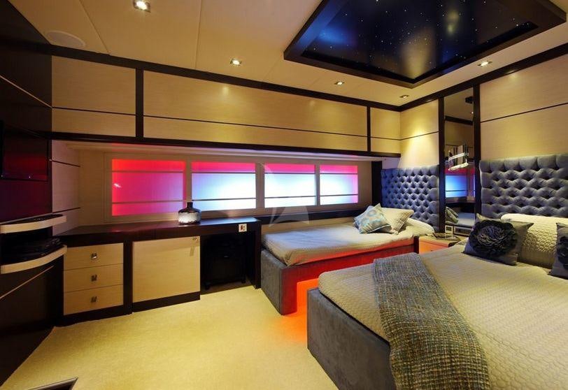 a room with a bed and a tv aboard PERLA DEL MARE Yacht for Charter