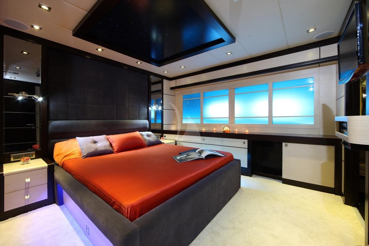 a room with a bed and a tv aboard PERLA DEL MARE Yacht for Charter
