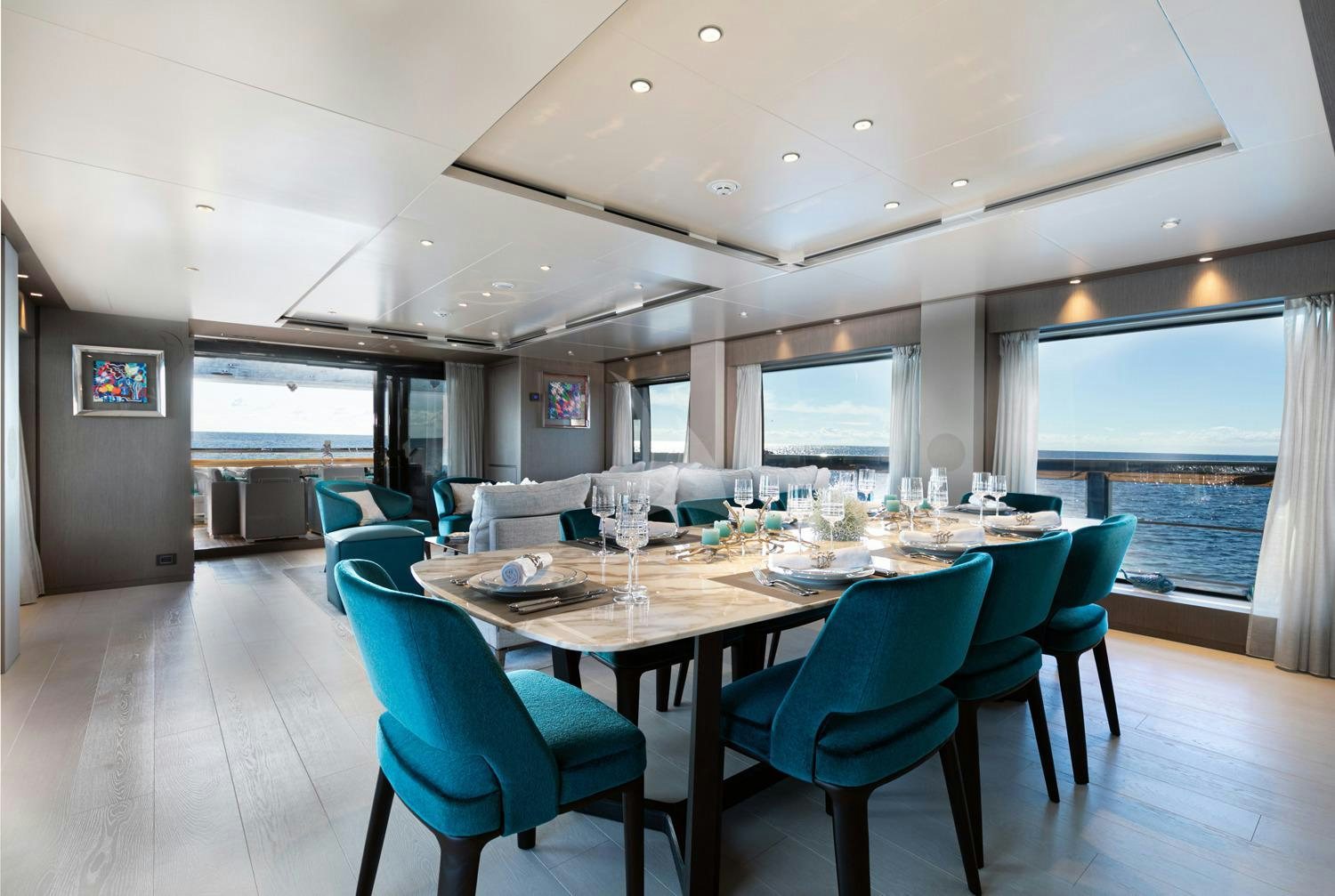 a large dining table with blue chairs aboard JAG'B Yacht for Charter