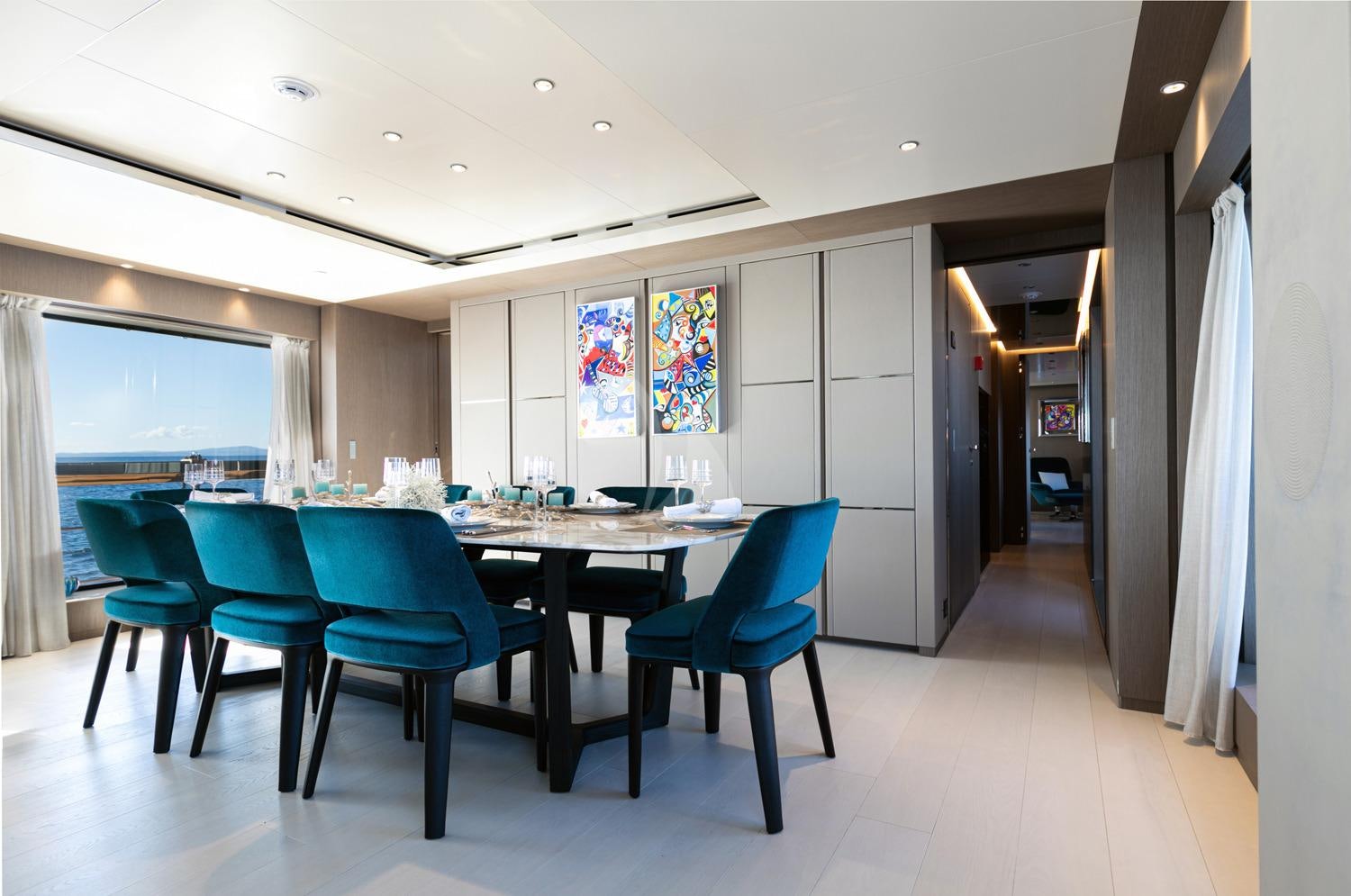 a room with a table and chairs aboard JAG'B Yacht for Charter