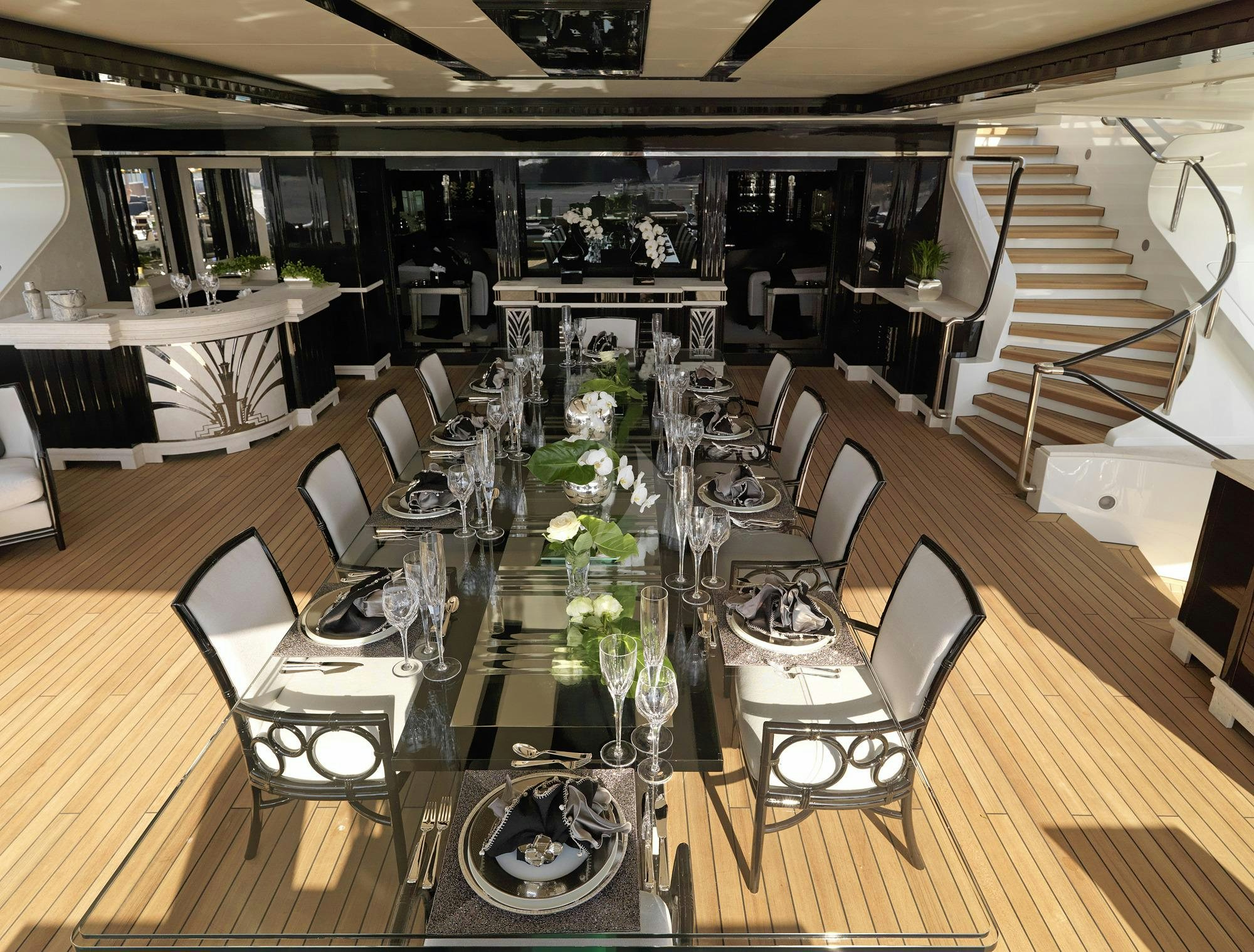 a dining room with a set of chairs and a staircase aboard SILVER ANGEL Yacht for Charter