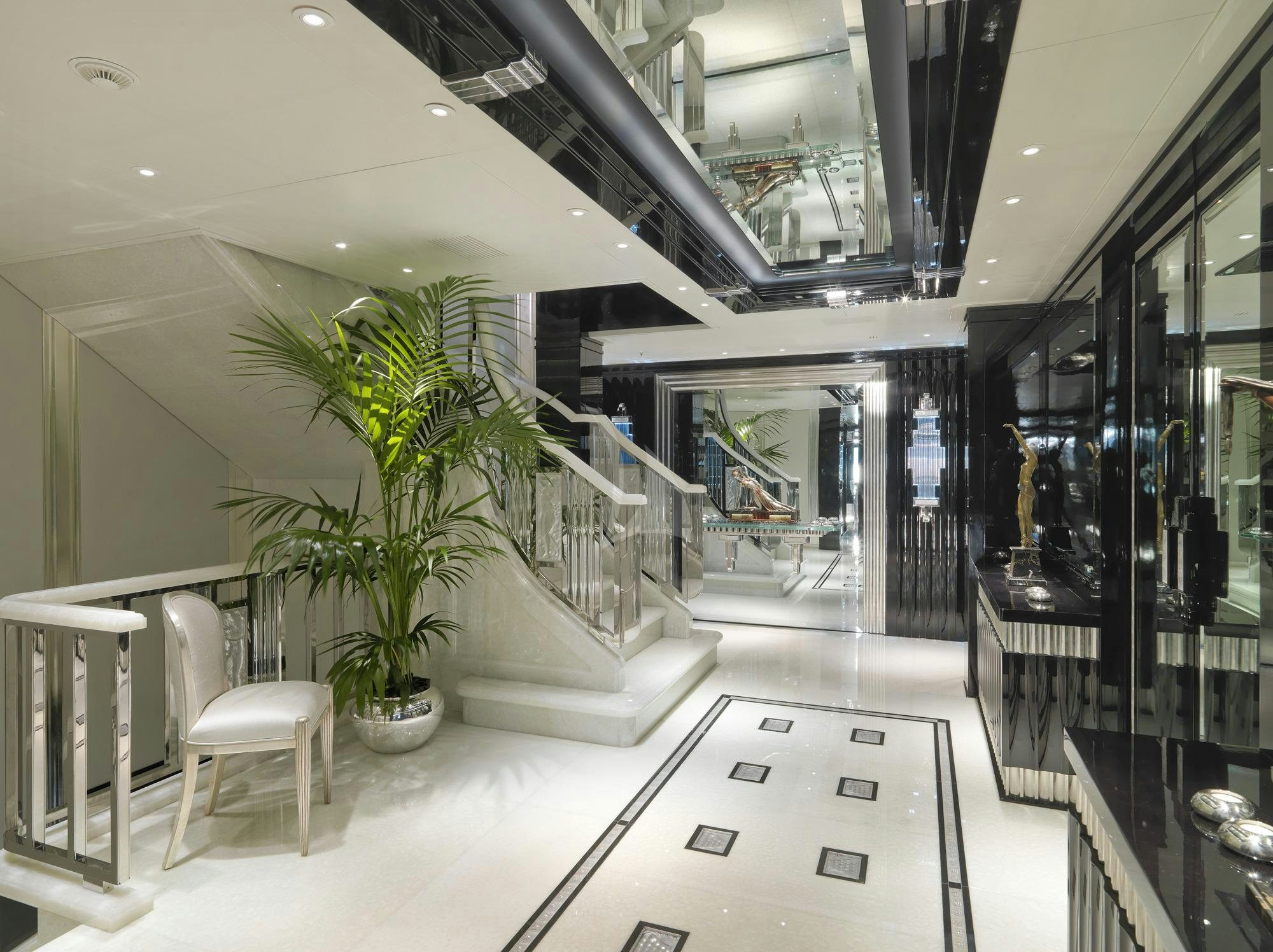 a room with a plant and chairs aboard SILVER ANGEL Yacht for Charter