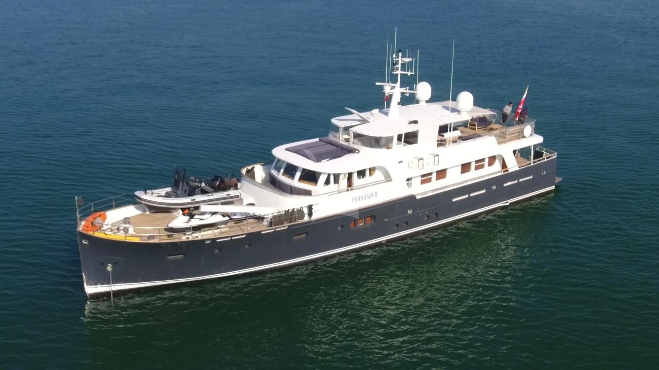 a large white boat in the water aboard PERSUADER Yacht for Charter