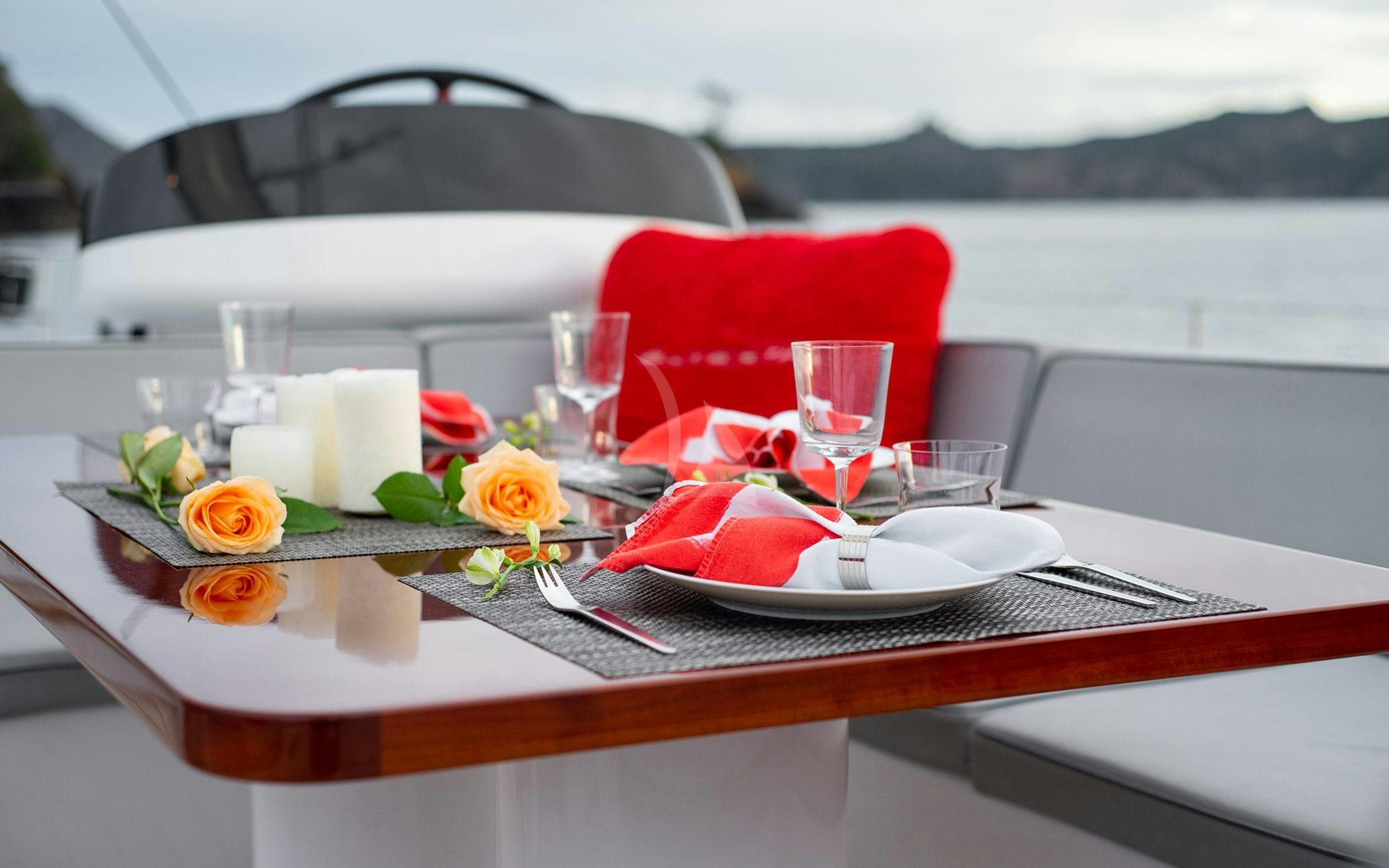 a table with plates and glasses on it aboard SILVERTIP Yacht for Charter