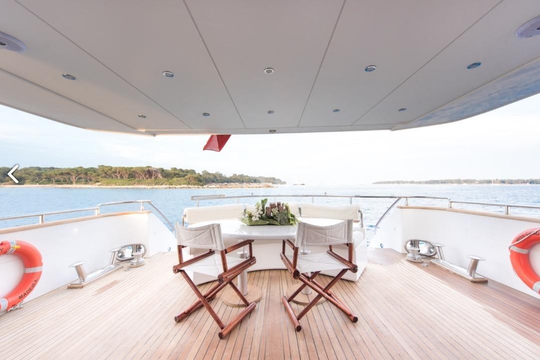 a table and chairs on a deck aboard MISS CANDY Yacht for Charter