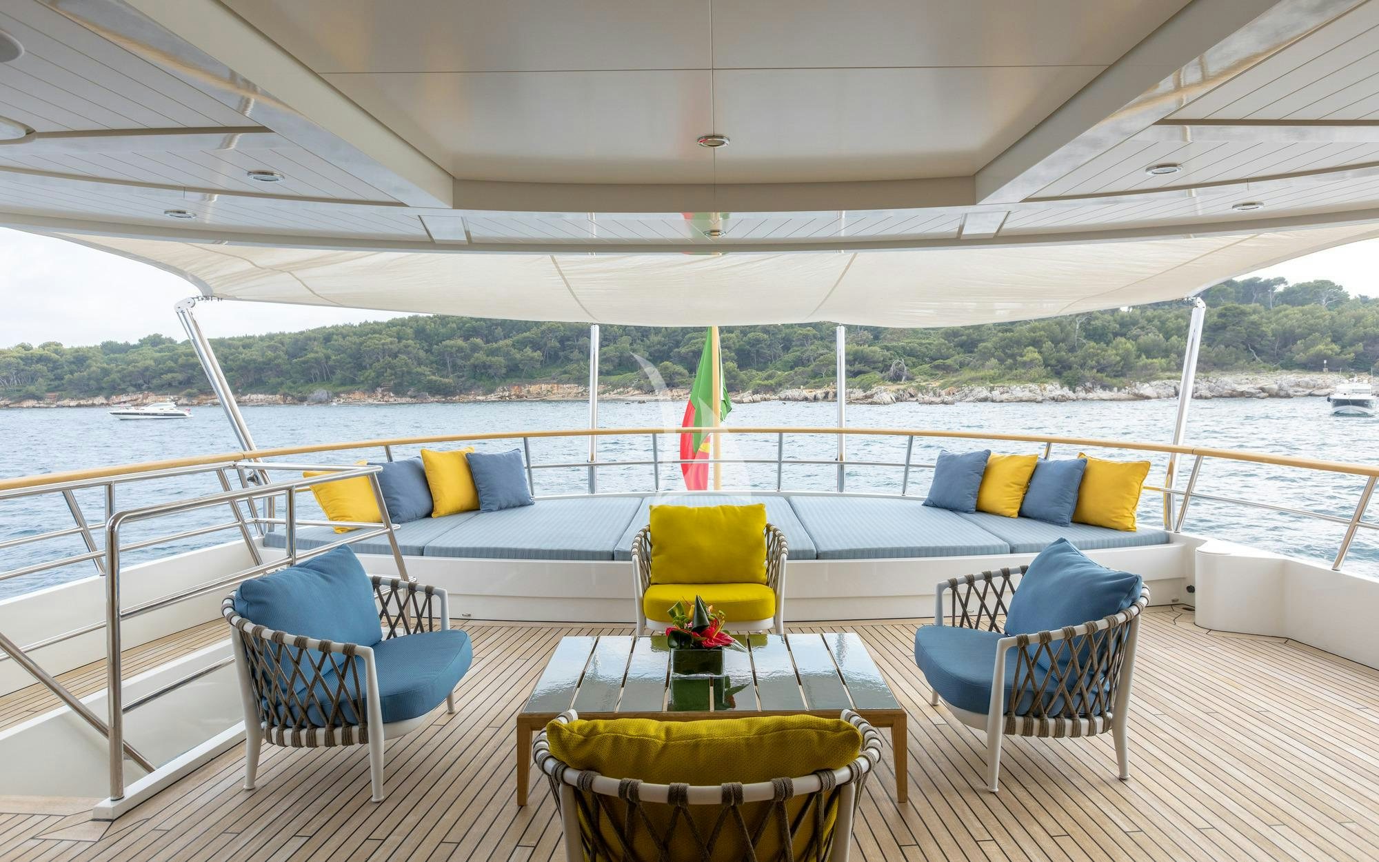 a deck with chairs and a table on it aboard ROBBIE BOBBY Yacht for Charter