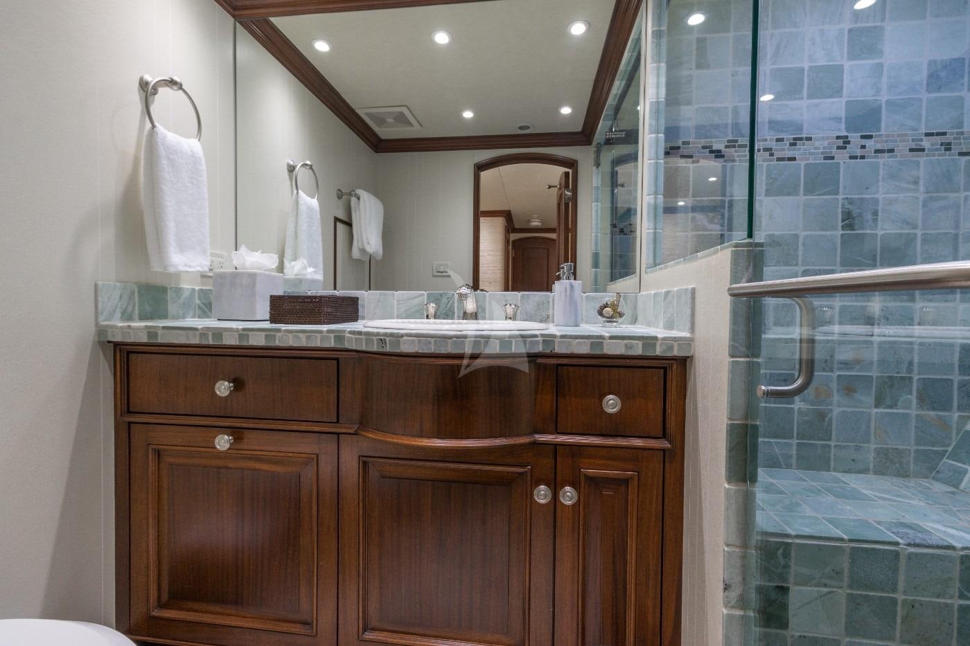 a bathroom with a glass shower aboard GITANA Yacht for Charter
