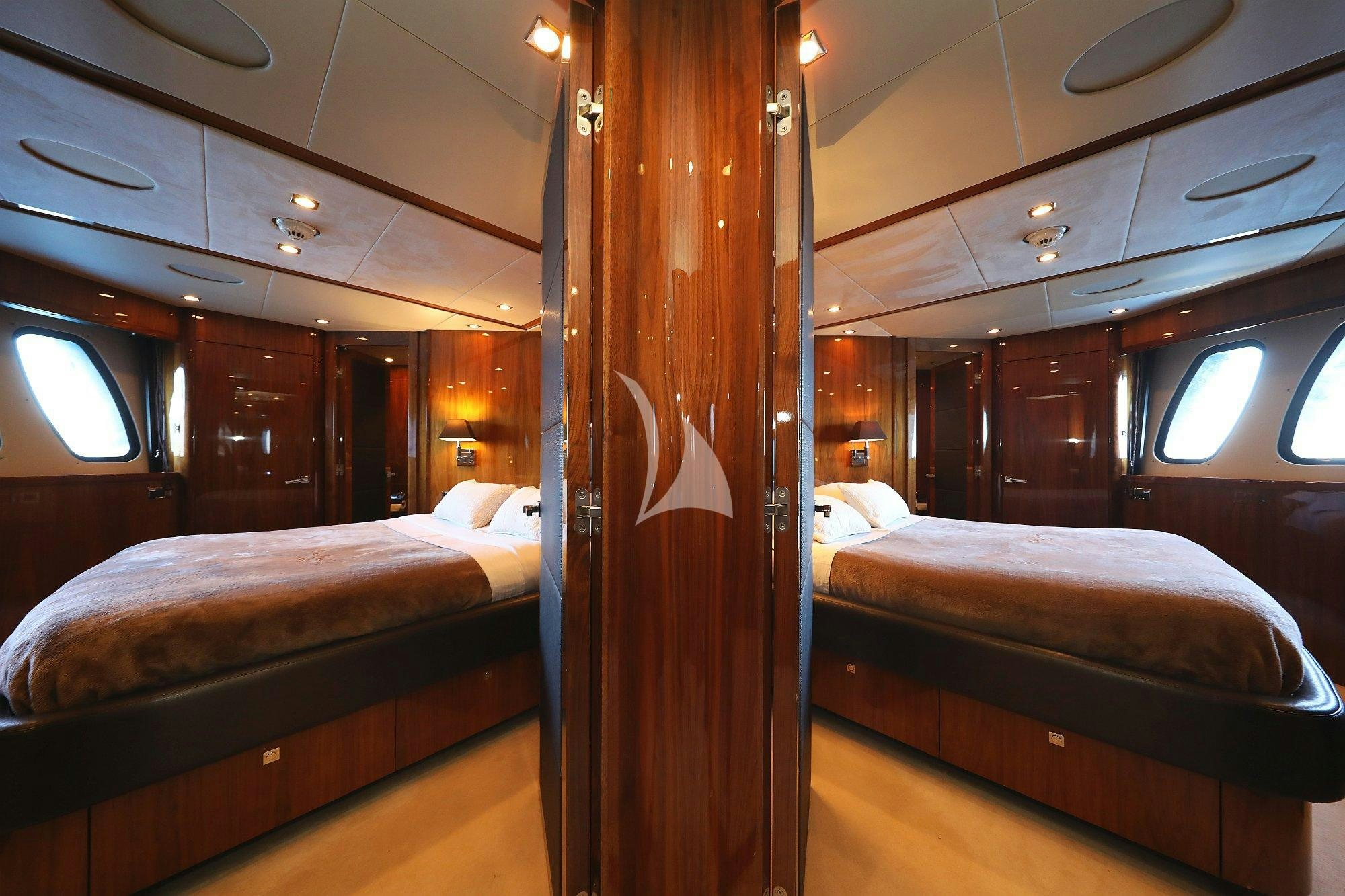 a room with two beds aboard ARAGO Yacht for Charter