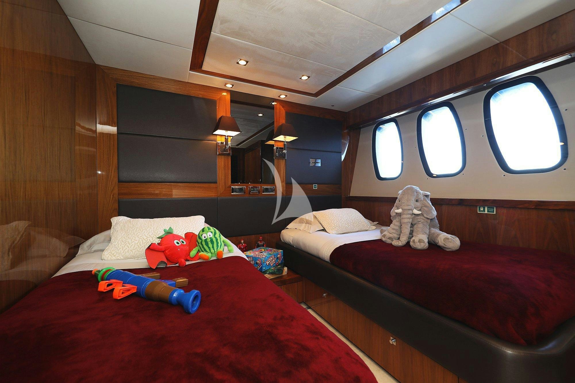 a room with bunk beds and a teddy bear aboard ARAGO Yacht for Charter