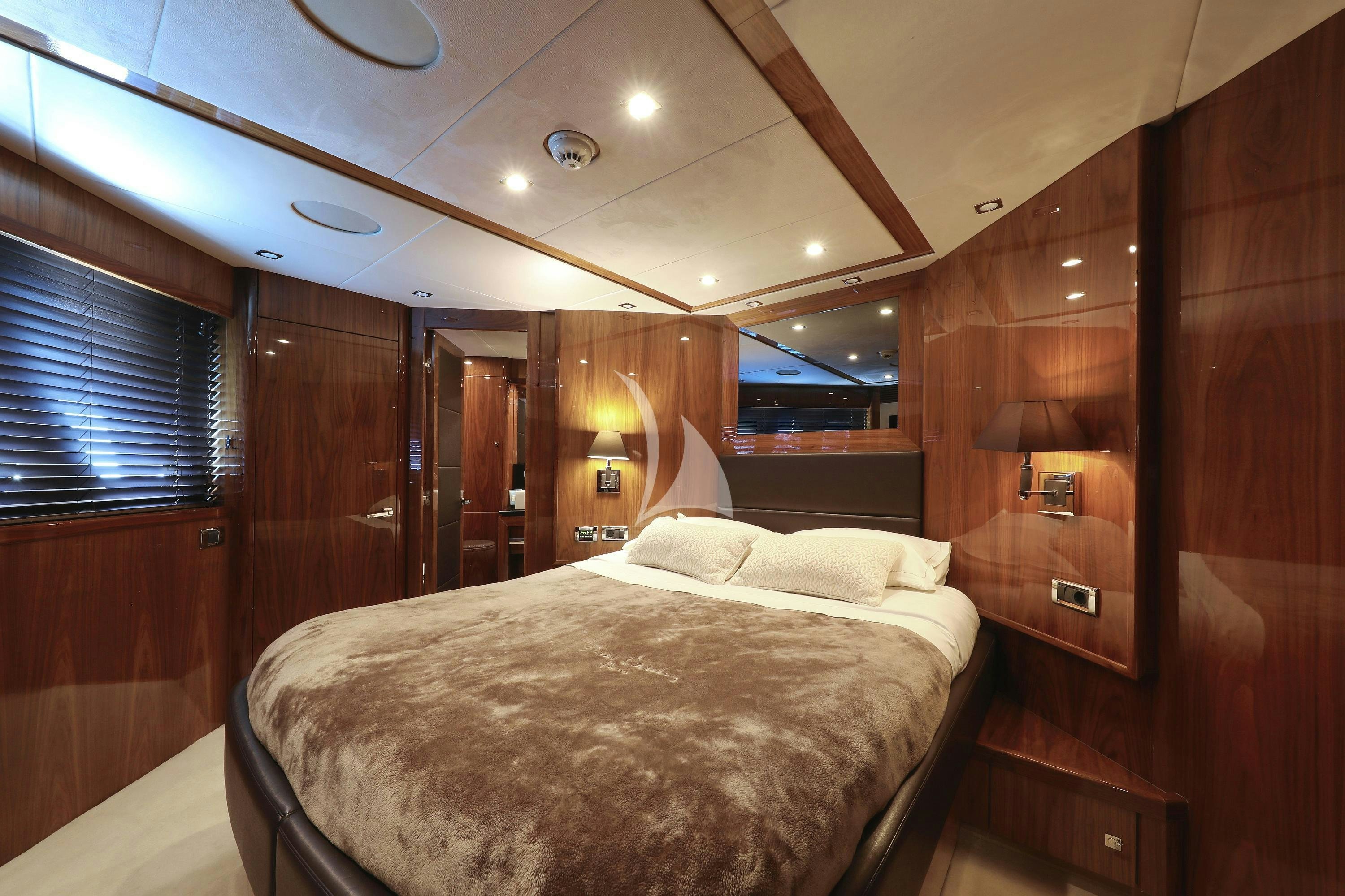 a bedroom with a bed and a wood wall aboard ARAGO Yacht for Charter