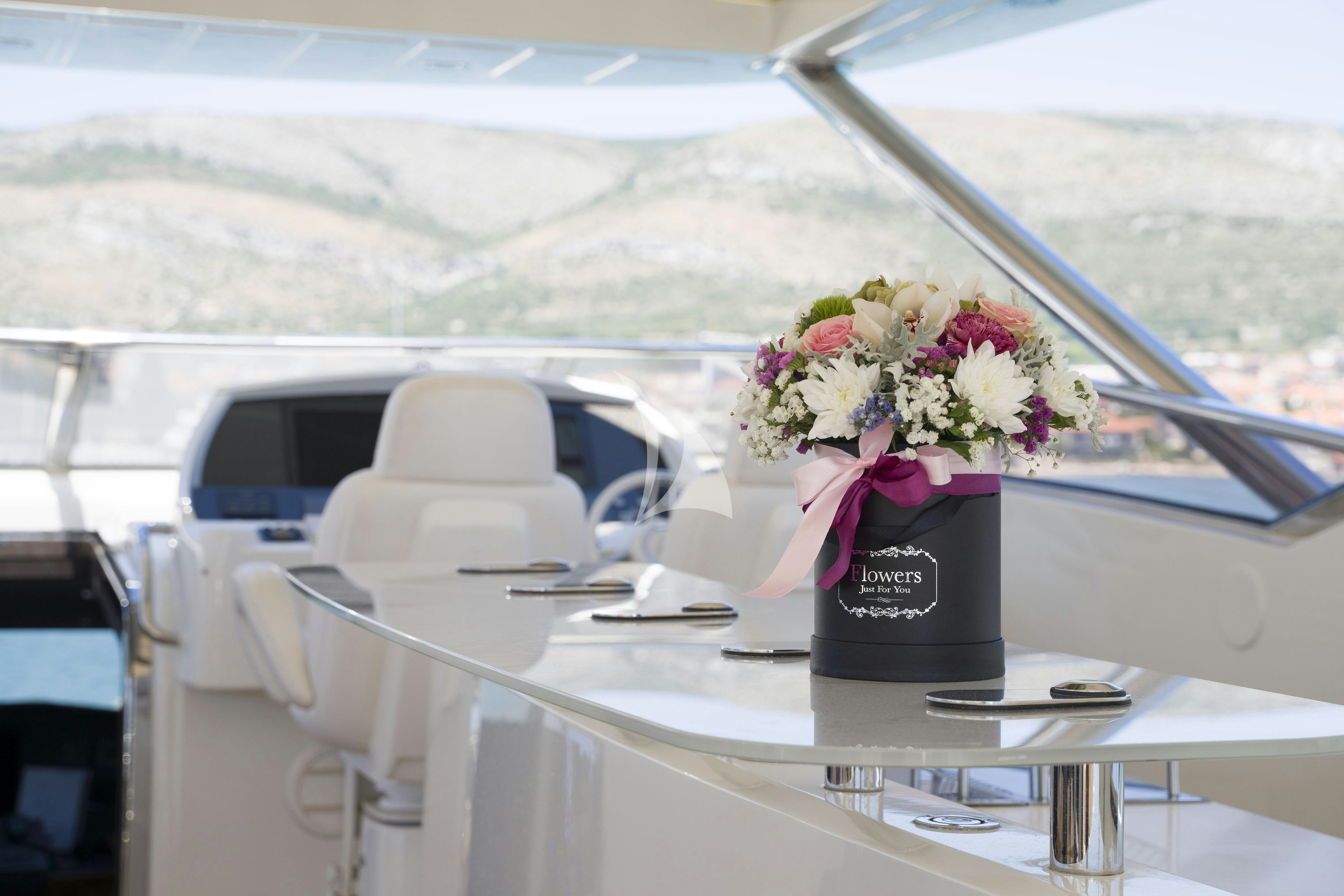 a vase of flowers on a table aboard ARAGO Yacht for Charter