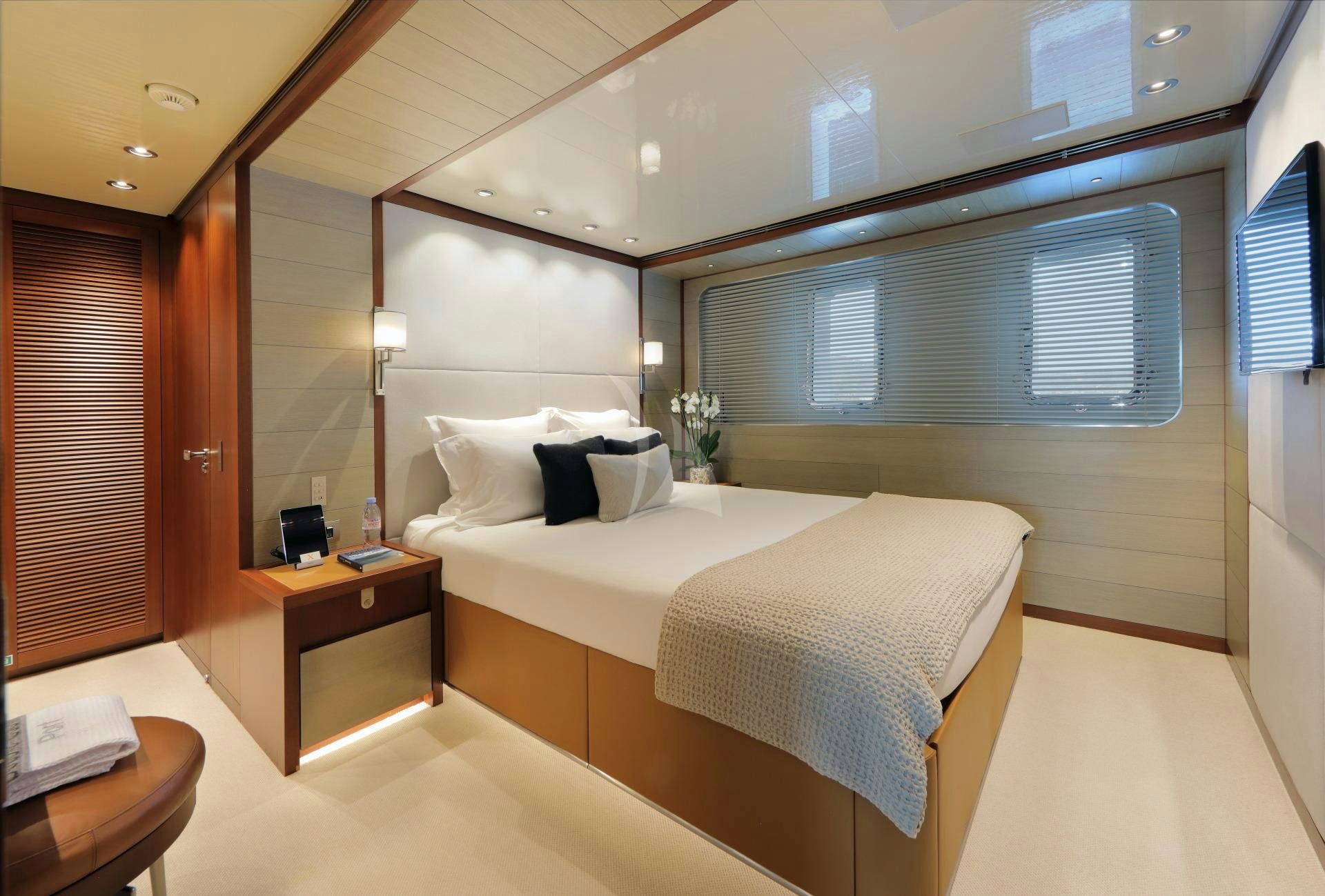 a large bedroom with a large bed aboard X Yacht for Charter