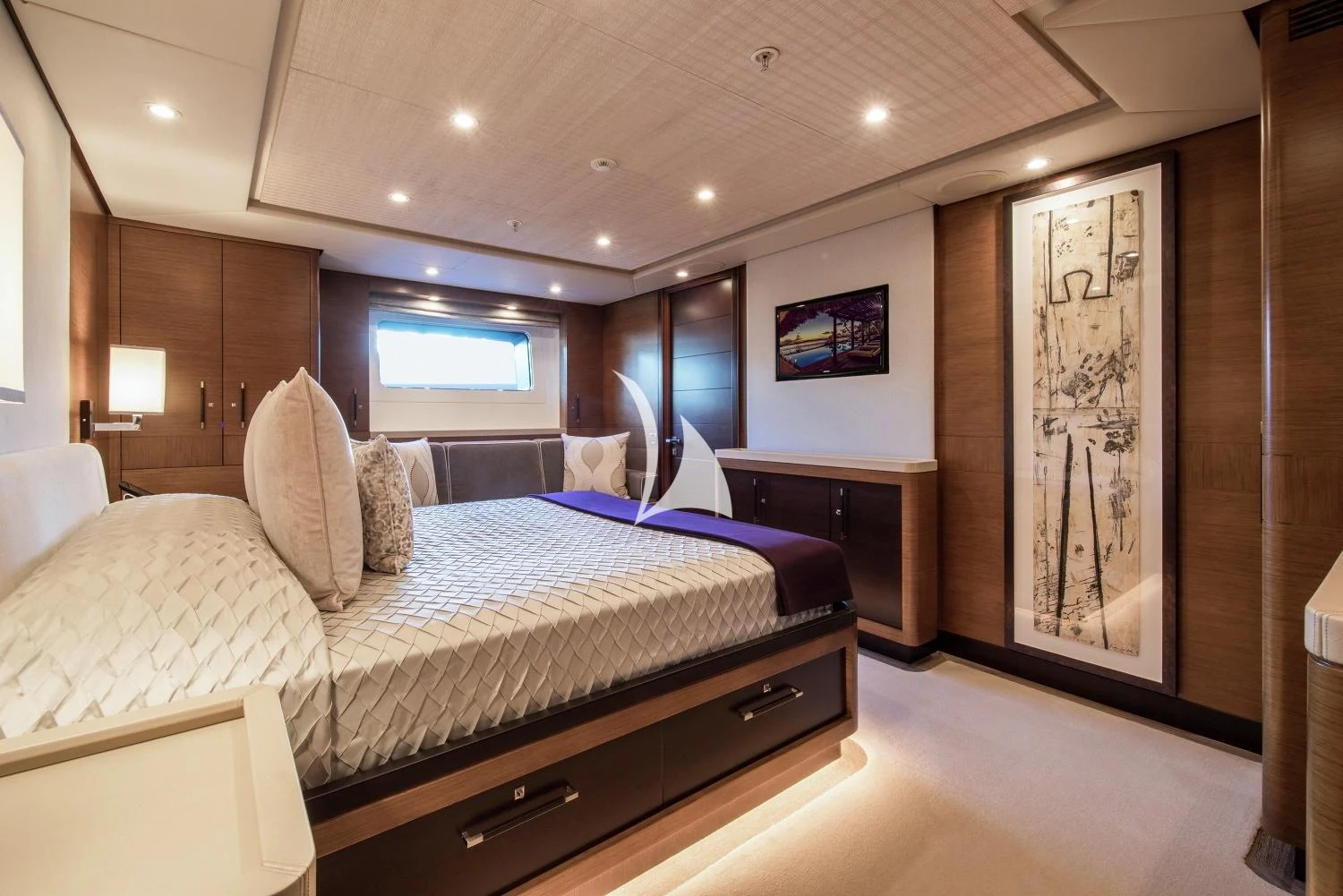 a bedroom with a large bed aboard KOKOMO Yacht for Charter