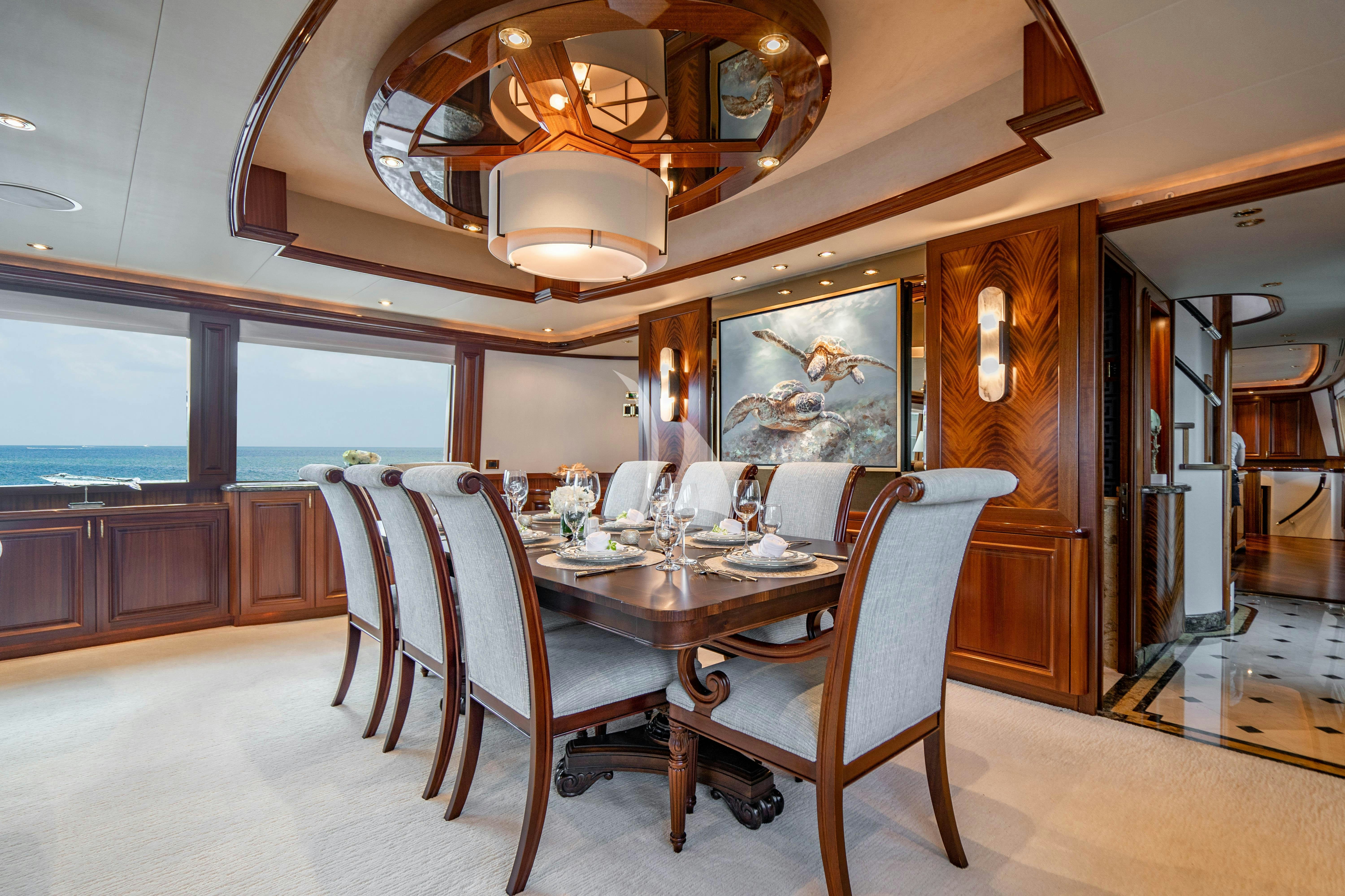 a dining room with a table and chairs aboard NOW OR NEVER Yacht for Charter