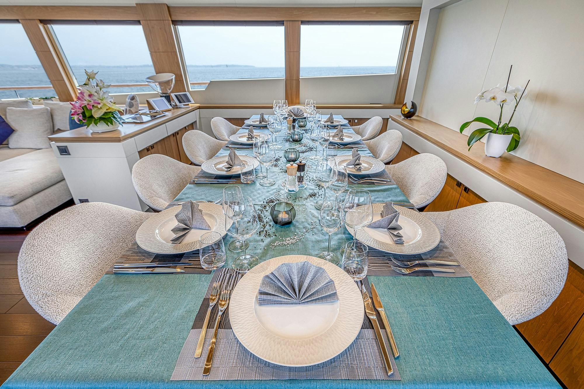 a table set with plates and silverware aboard MILLESIME Yacht for Charter