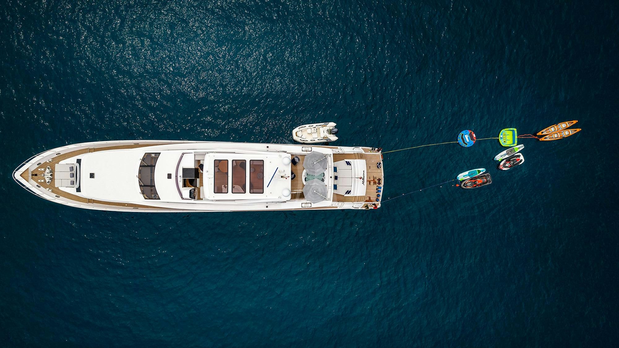 a helicopter flying over a boat in the ocean aboard MILLESIME Yacht for Charter