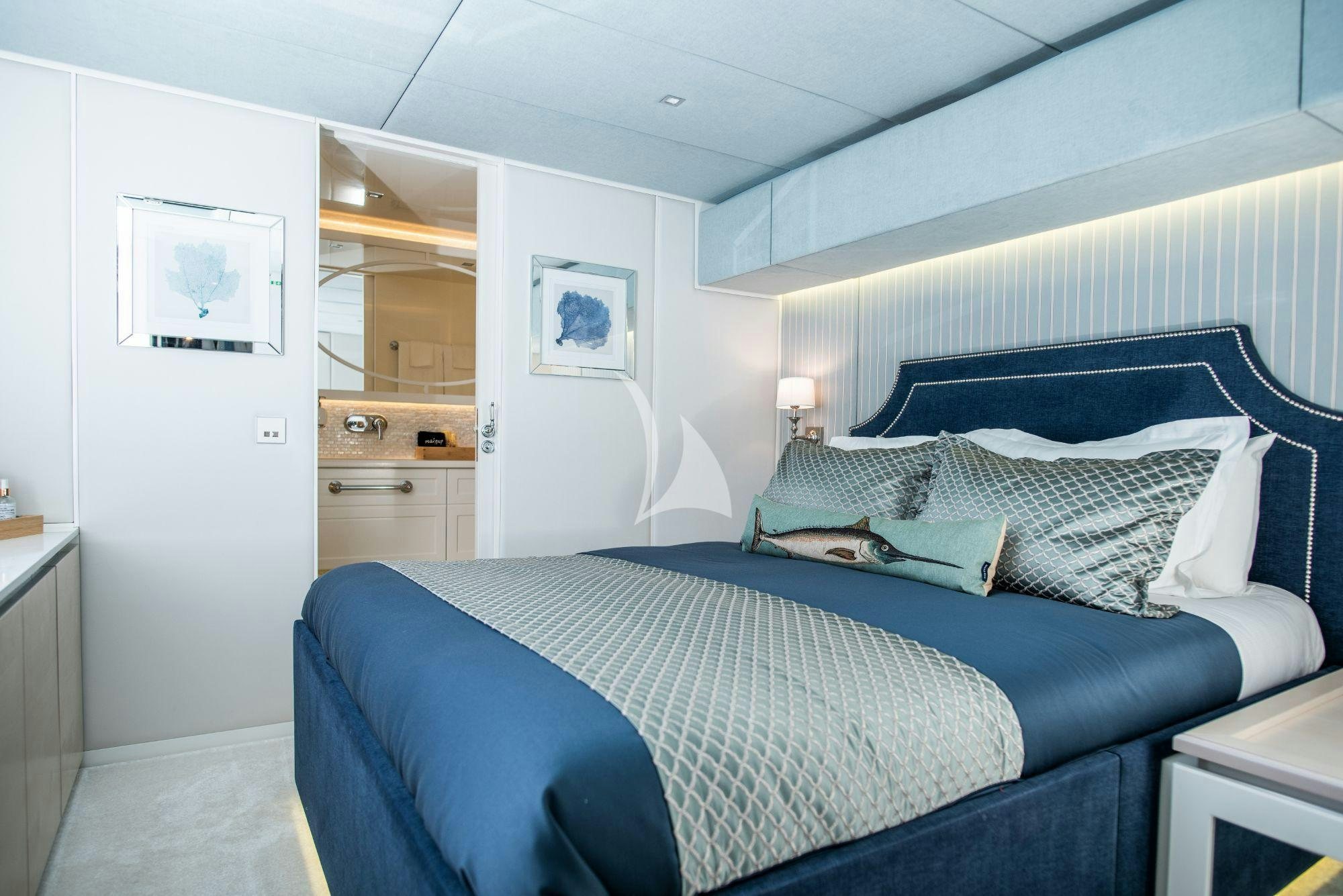 a bedroom with a blue bed aboard BUNDALONG Yacht for Charter