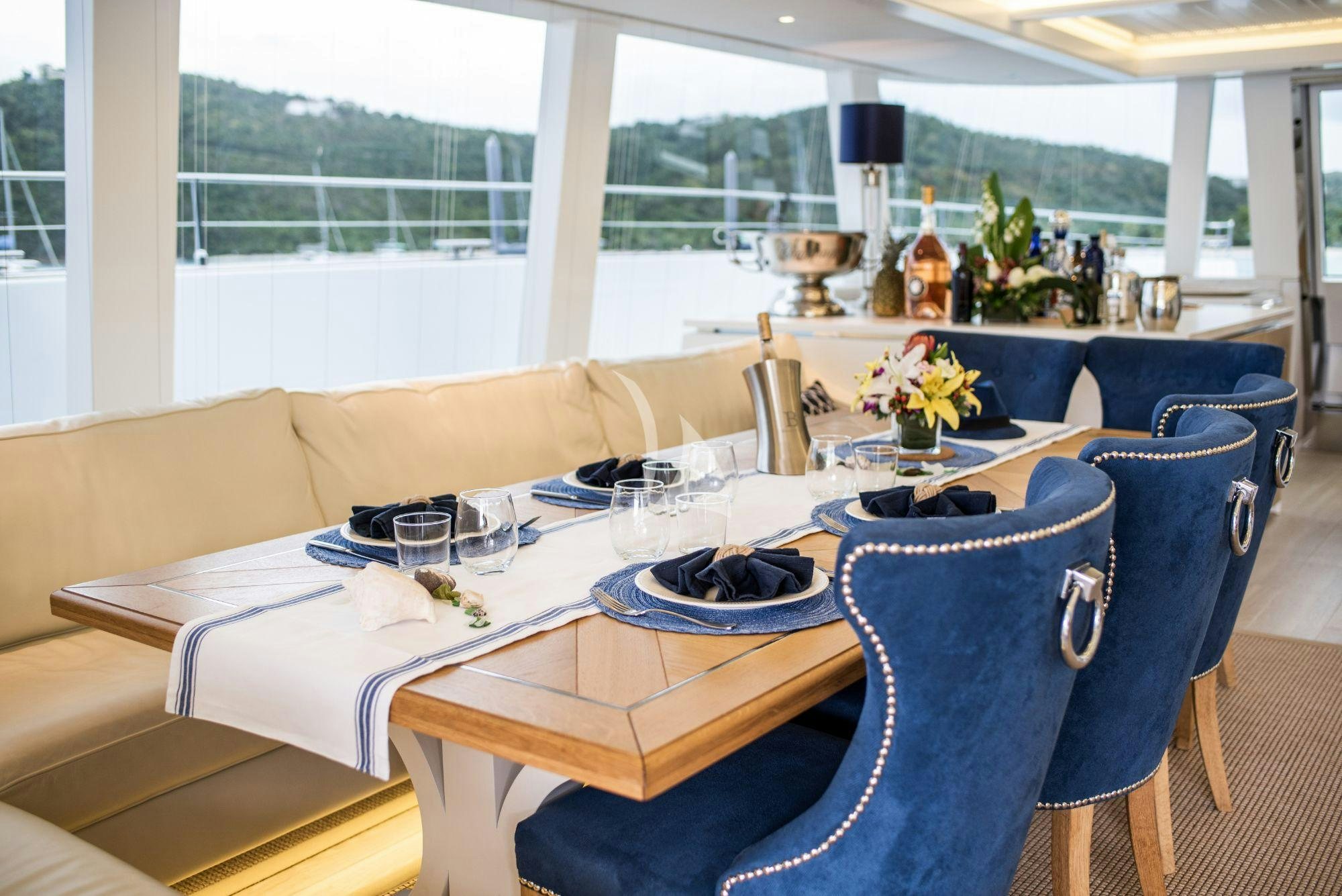 a table with plates and cups on it aboard BUNDALONG Yacht for Charter