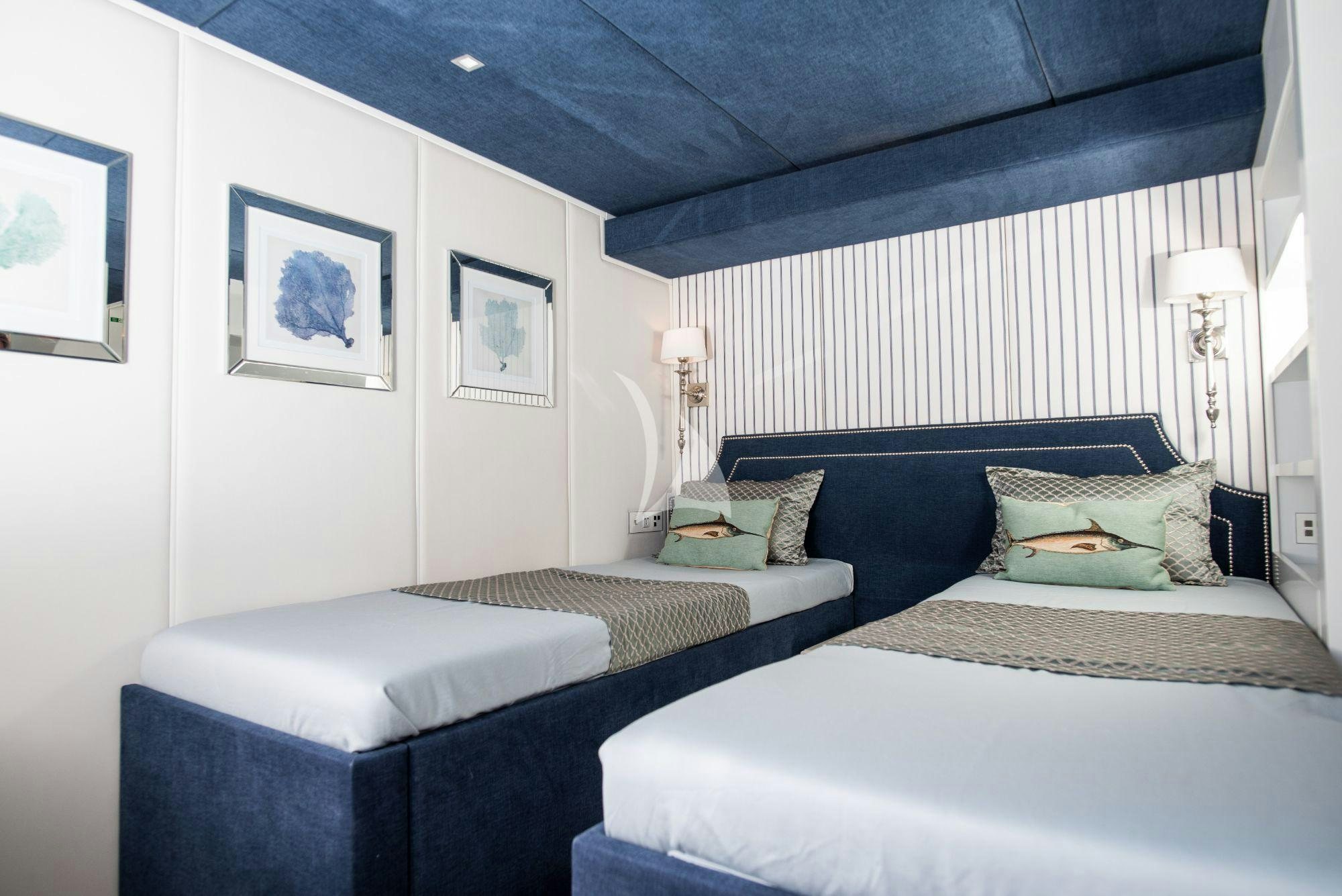 a room with a couple of beds aboard BUNDALONG Yacht for Charter