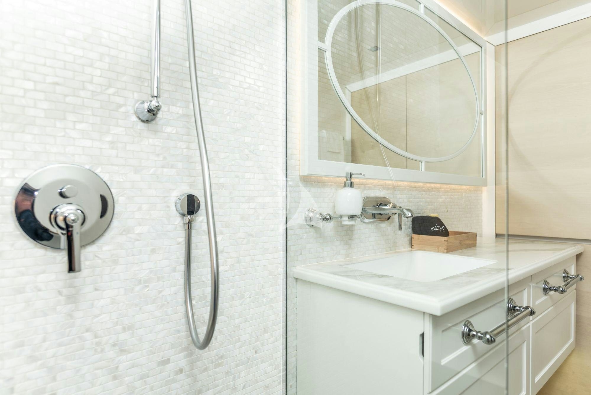 a bathroom with a mirror and a sink aboard BUNDALONG Yacht for Charter