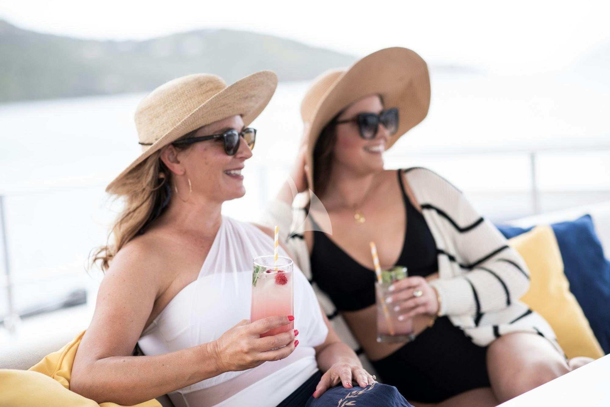 a couple of women sitting in a boat and drinking aboard BUNDALONG Yacht for Charter