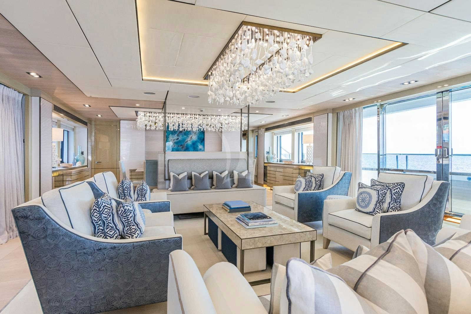 a living room with a large chandelier aboard THUMPER Yacht for Charter