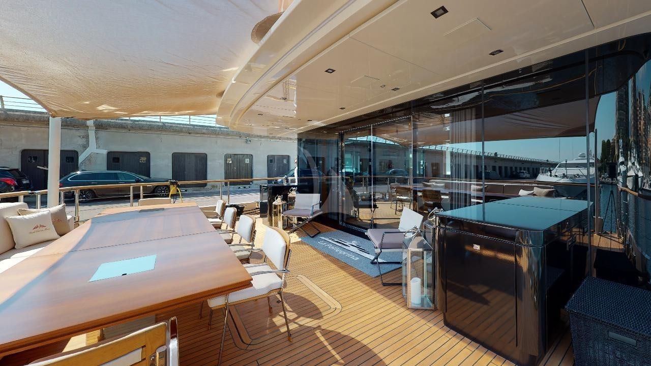 a room with tables and chairs aboard LA PELLEGRINA 1 Yacht for Charter