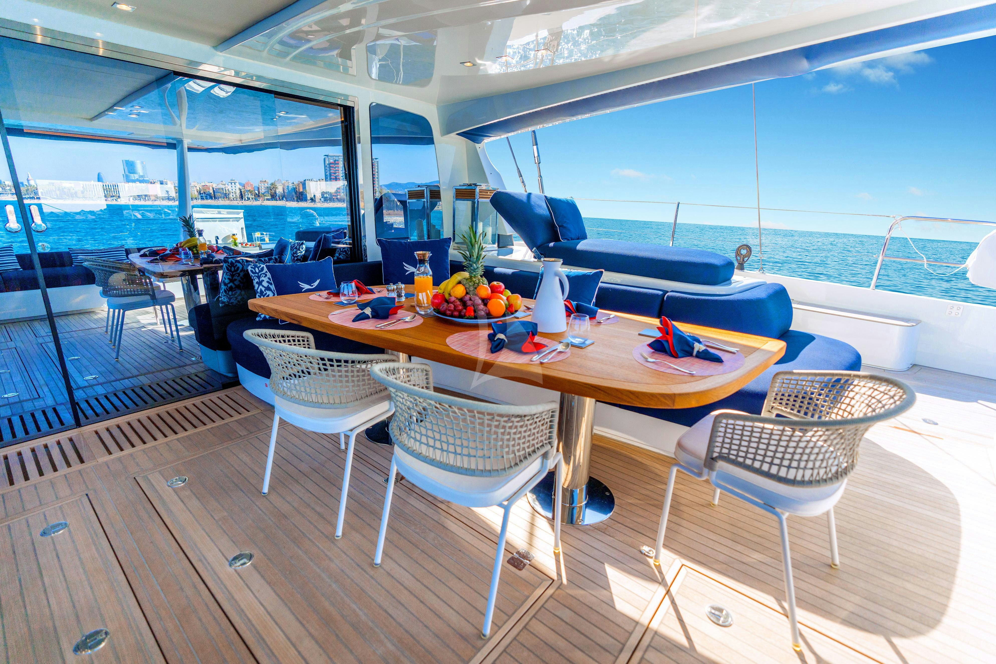 a table and chairs on a deck aboard MARIAH PRINCESS III Yacht for Charter
