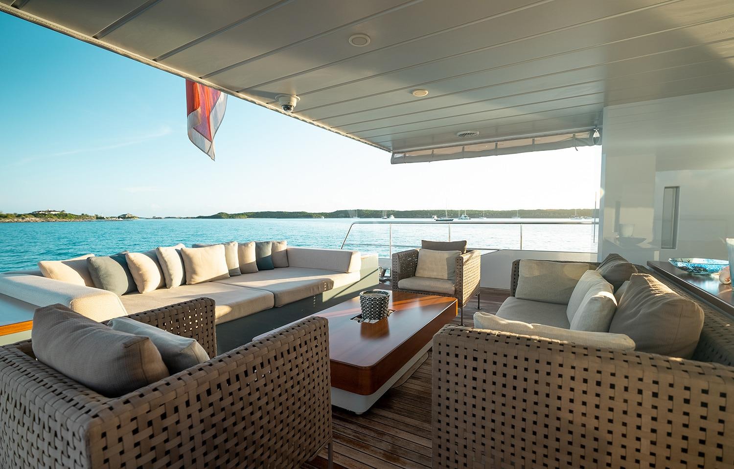 a living room with a large sofa and a large window aboard ONLY NOW Yacht for Charter