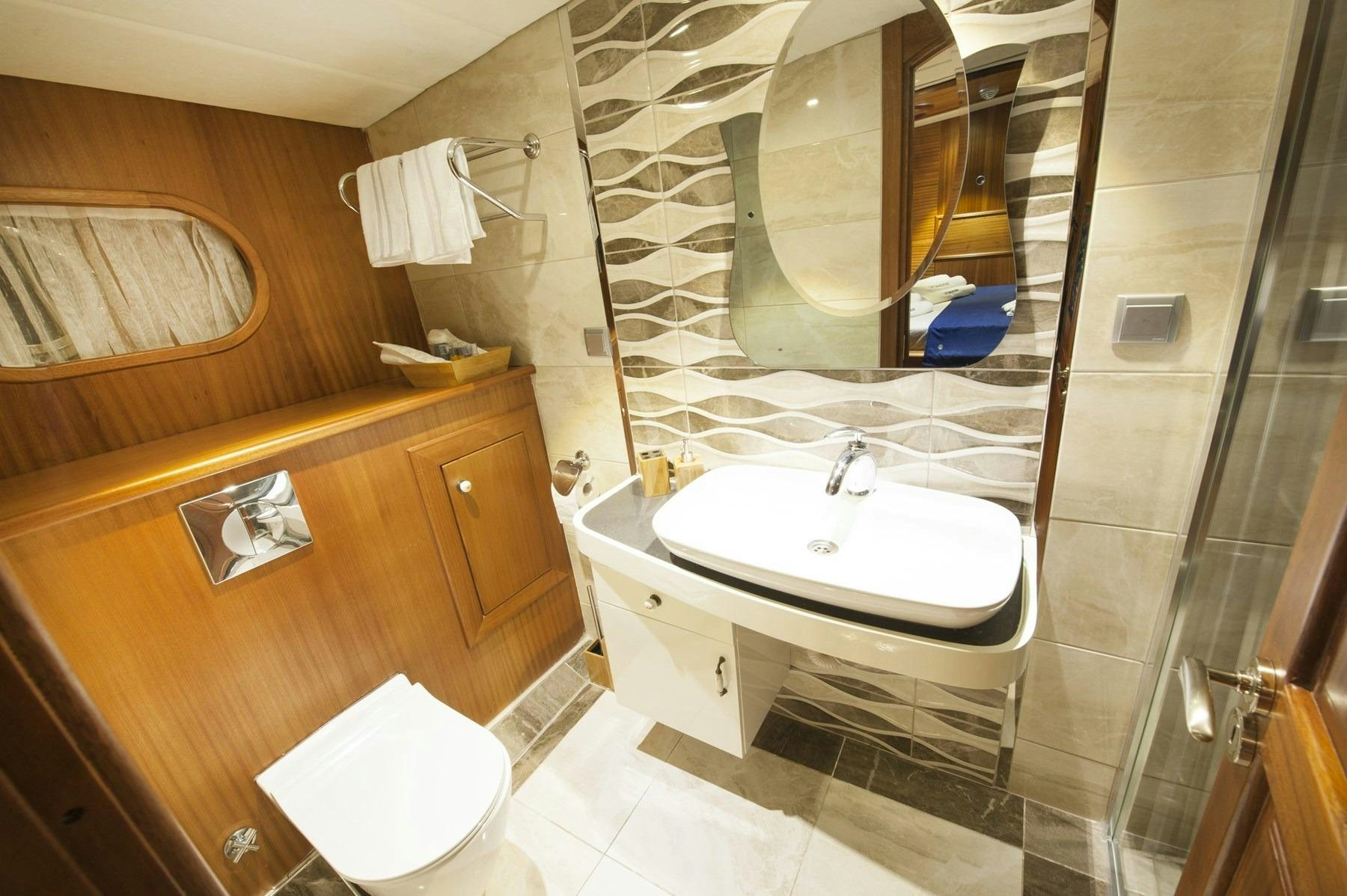 a bathroom with a sink and a mirror aboard BERRAK SU Yacht for Charter