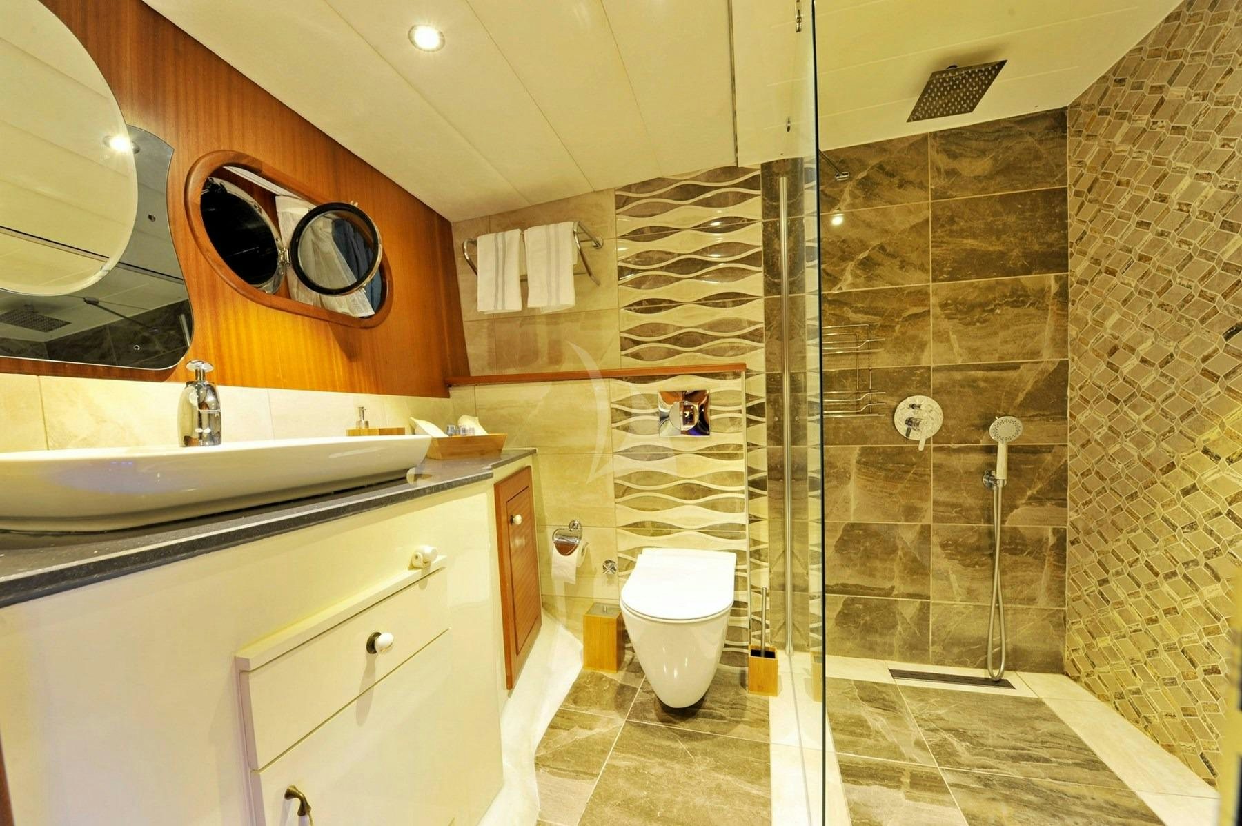 a bathroom with a glass shower aboard BERRAK SU Yacht for Charter