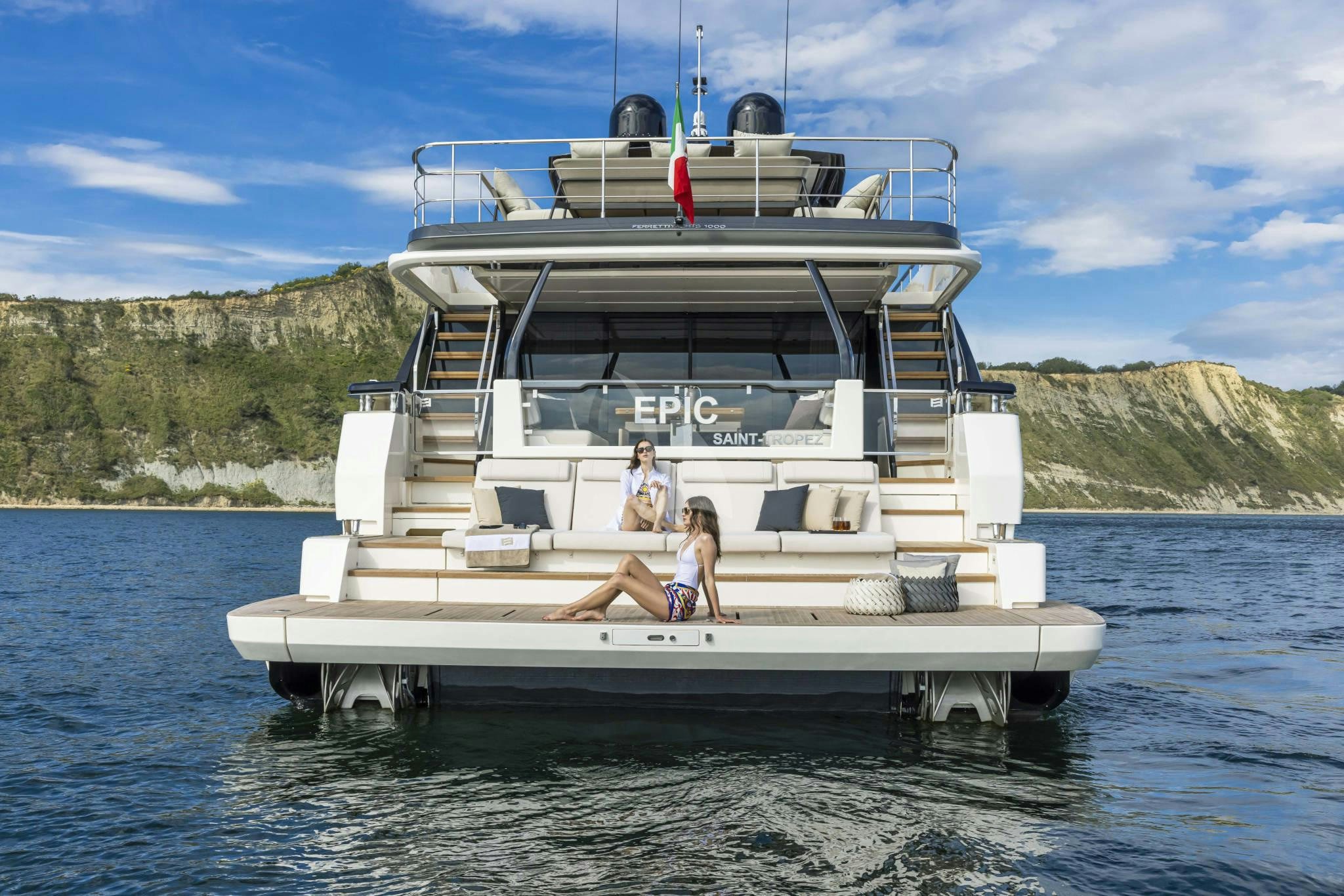 a couple of people sitting on a boat in the water aboard EPIC Yacht for Charter