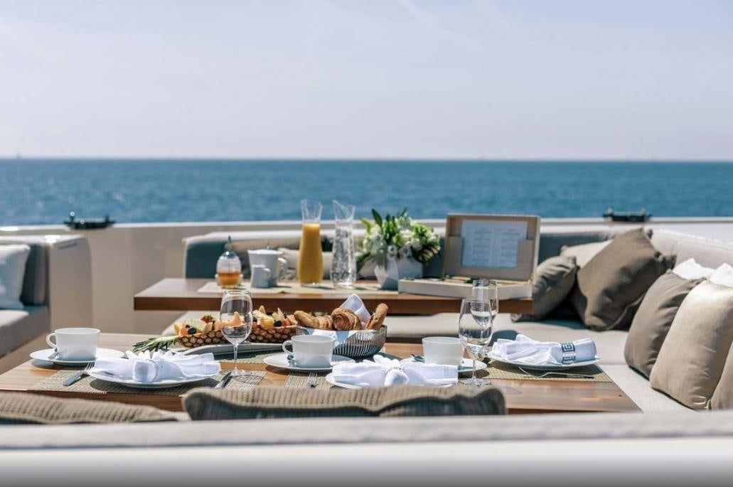 a table with food and drinks on it aboard VERTIGE Yacht for Charter